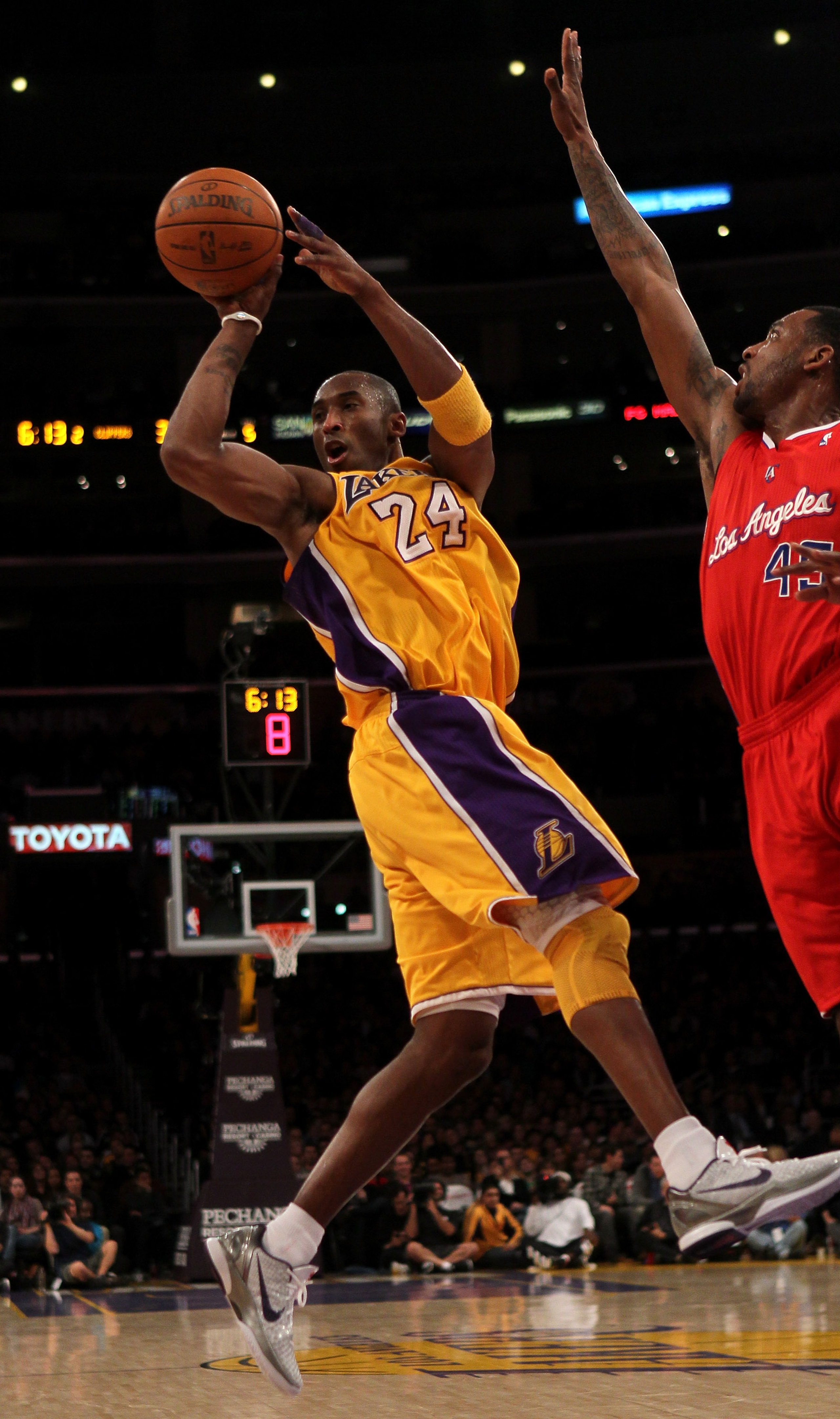 LOS ANGELES, CA - FEBRUARY 25:  Kobe Bryant #24 of  the Los Angeles Lakers passes off the ball in front of Rasual Butler #45 of the Los Angeles Clippers at Staples Center on February 25, 2011 in Los Angeles, California. The Lakers won 100-88.  NOTE TO USE
