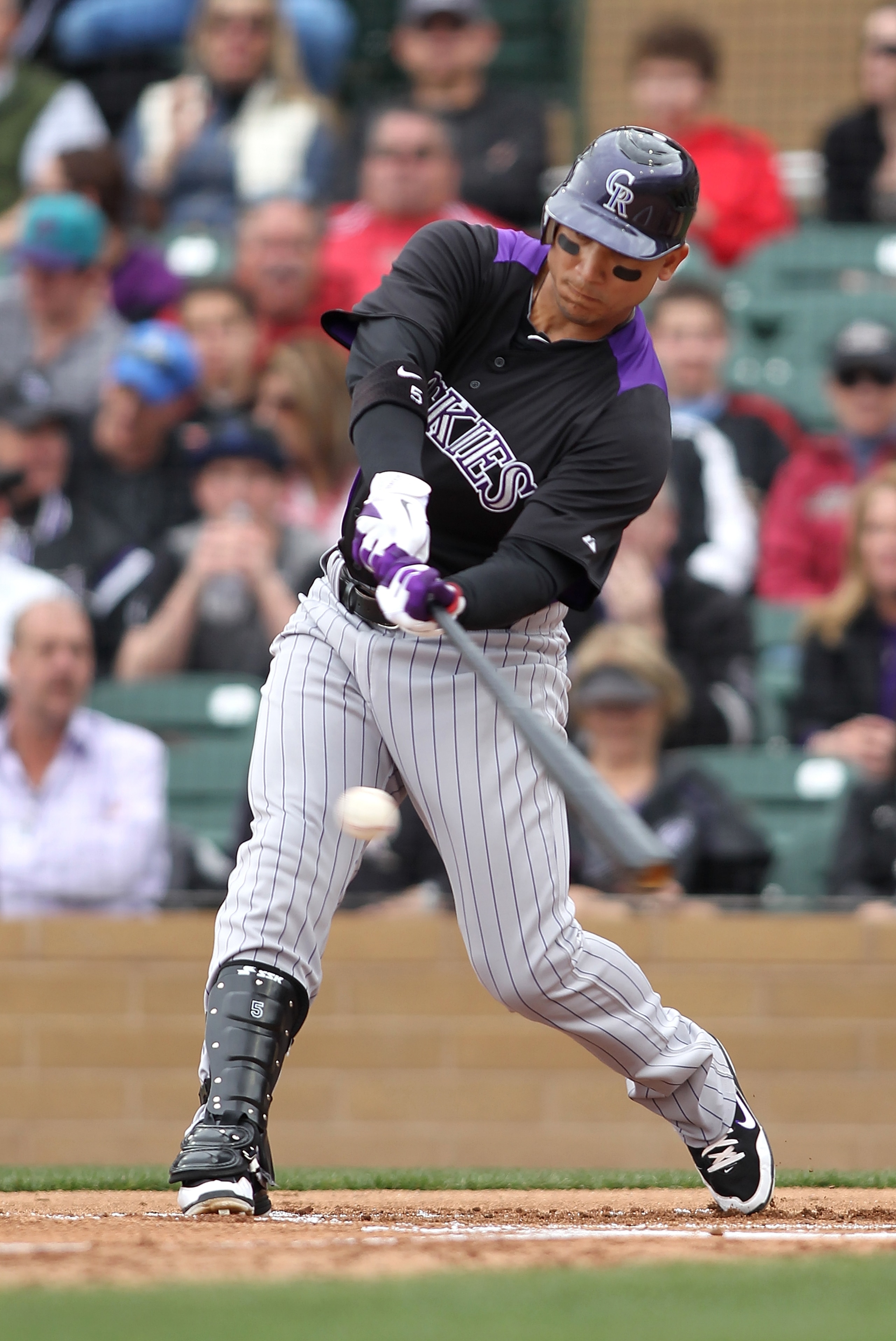 SCOTTSDALE, AZ - FEBRUARY 26:  Carlos Gonzalez #5 of the Colorado Rockies swings during the game against the Arizona Diamondbacks at Salt River Fields on February 26, 2011in Scottsdale, Arizona..  (Photo by Jonathan Ferrey/Getty Images)