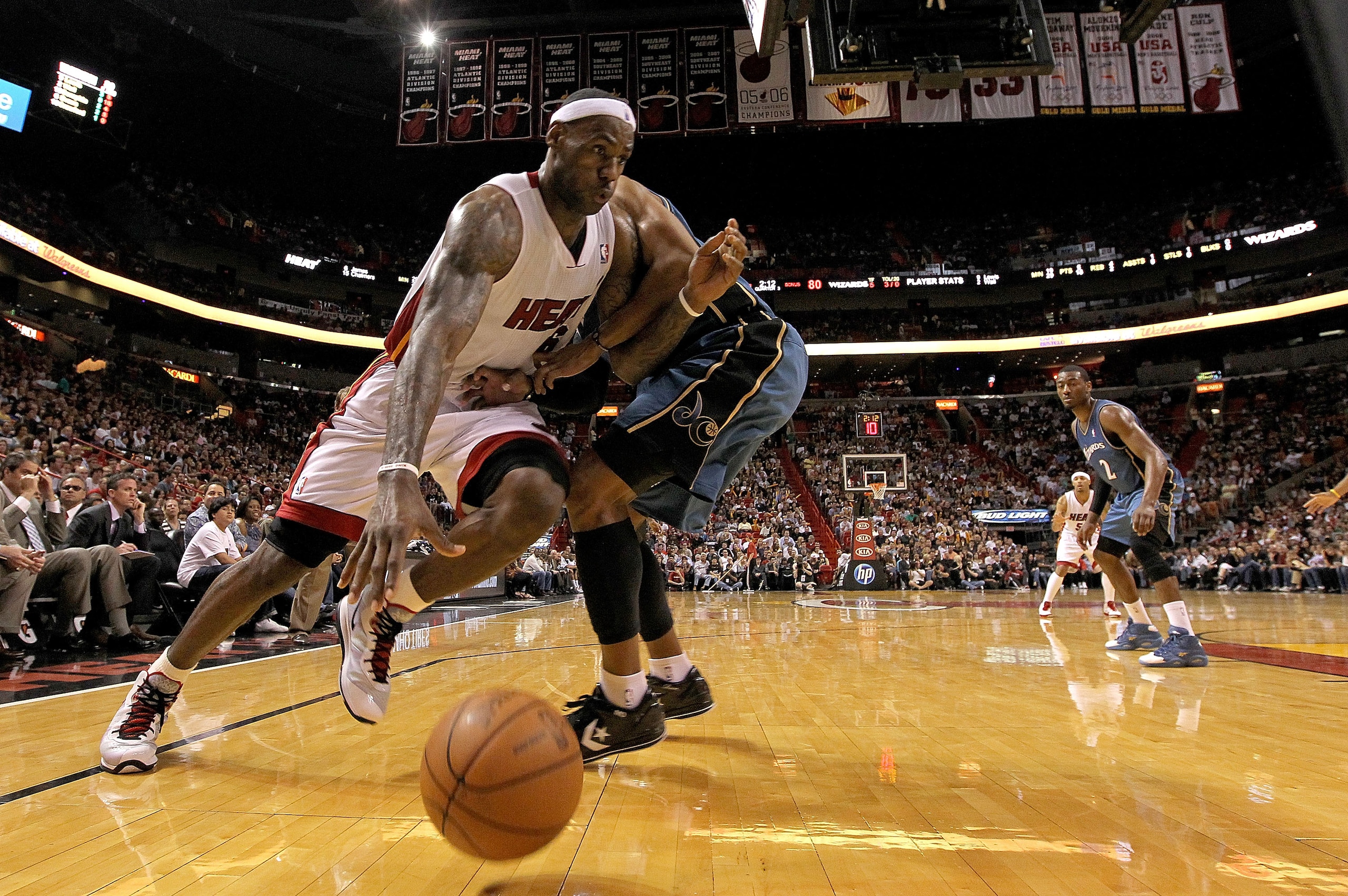 MIAMI, FL - FEBRUARY 25:  LeBron James #6 of the Miami Heat drives around Maurice Evans #6 of the Washington Wizards during a game at American Airlines Arena on February 25, 2011 in Miami, Florida. NOTE TO USER: User expressly acknowledges and agrees that