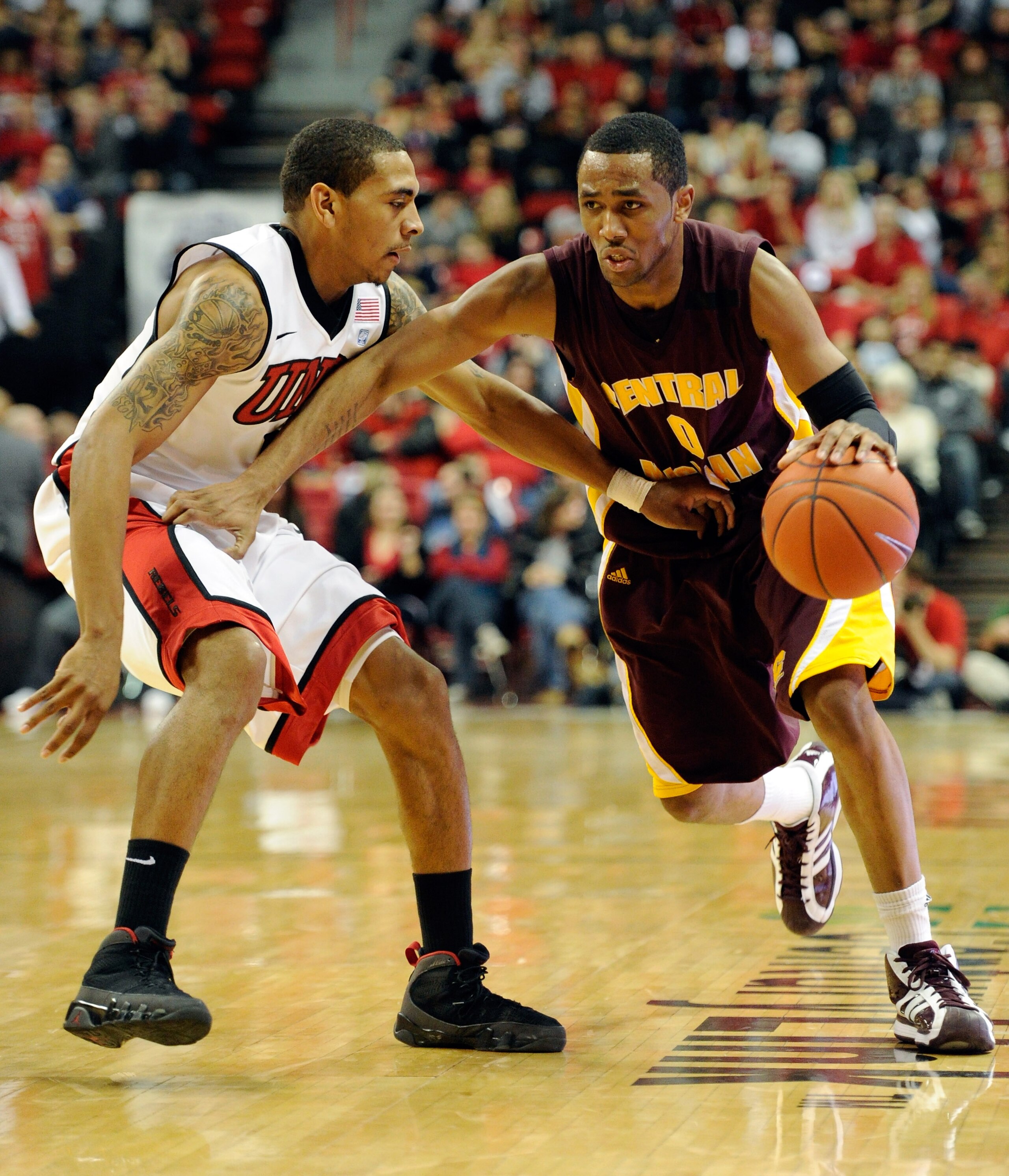 LAS VEGAS, NV - DECEMBER 30:  Trey Zeigler #0 of the Central Michigan Chippewas brings the ball up the court against Anthony Marshall #3 of the UNLV Rebels during their game at the Thomas & Mack Center December 30, 2010 in Las Vegas, Nevada. UNLV won 73-4