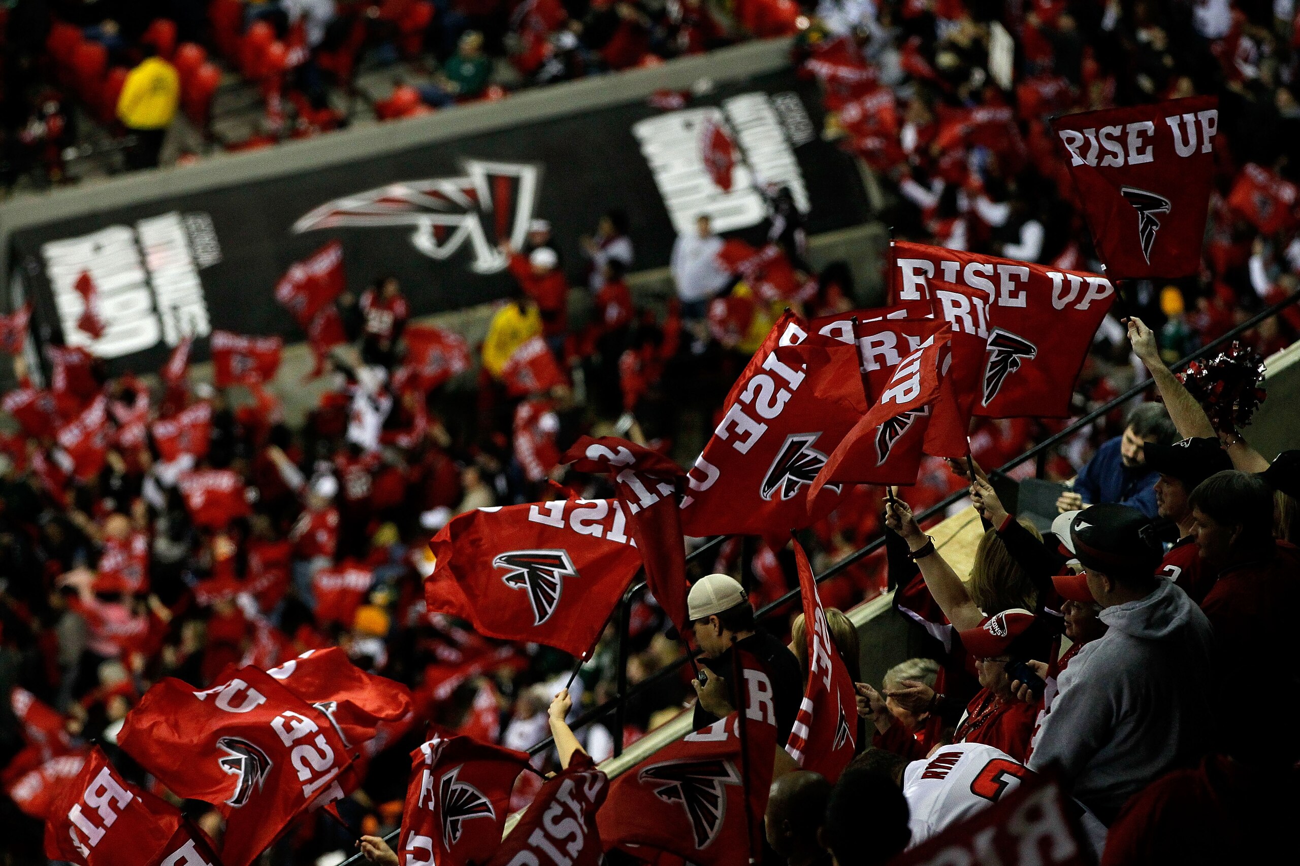 ATLANTA, GA - JANUARY 15:  Fans of the Atlanta Falcons wave flags which read 'Rise Up' against the Green Bay Packers during their 2011 NFC divisional playoff game at Georgia Dome on January 15, 2011 in Atlanta, Georgia.  (Photo by Kevin C. Cox/Getty Image