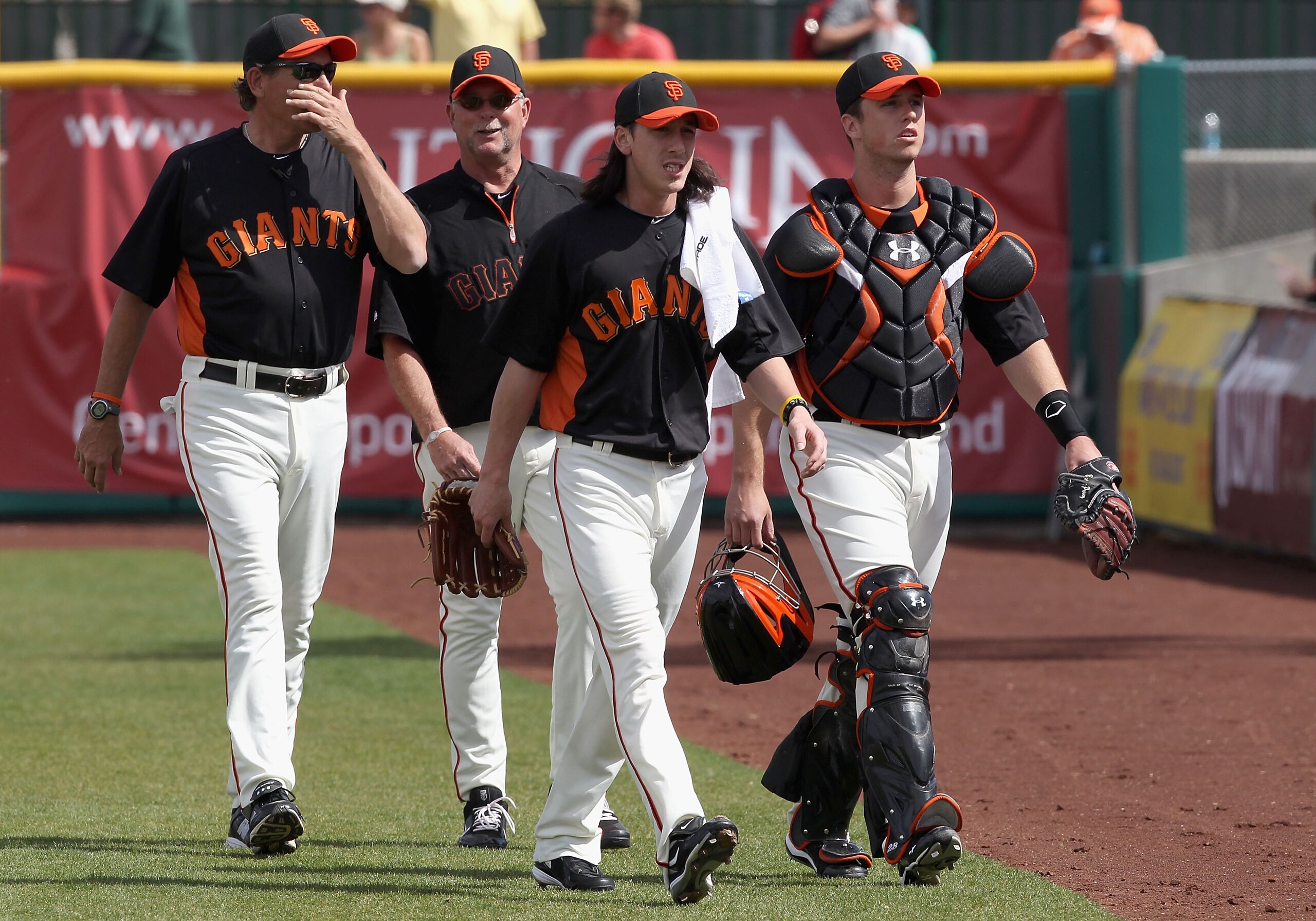 SCOTTSDALE, AZ - MARCH 01:  Starting pitcher Tim Lincecum ##55 and Buster Posey #28 of the San Francisco Giants walk to the dugout before during the spring training game against the Chicago Cubs at Scottsdale Stadium on March 1, 2011 in Scottsdale, Arizon