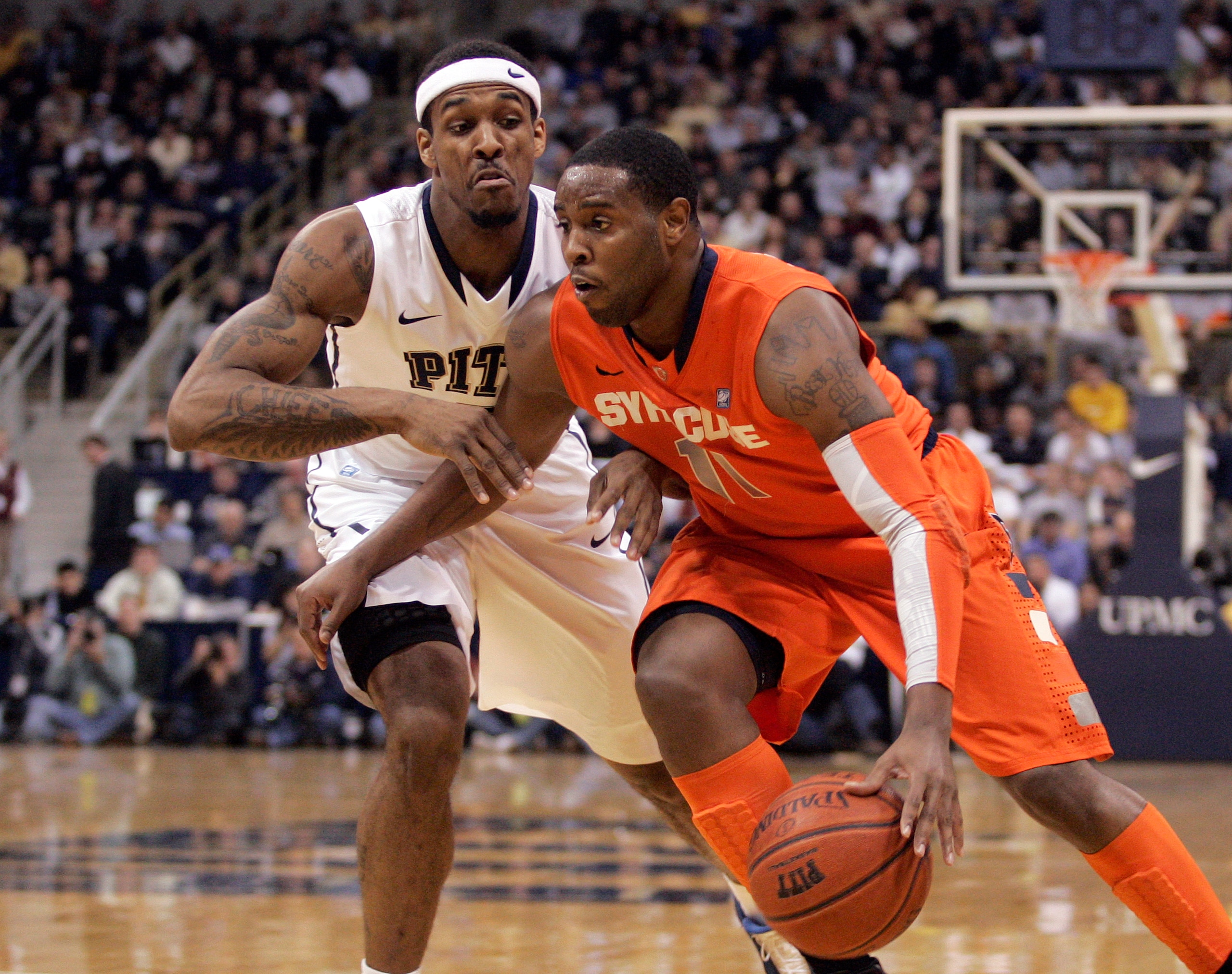 PITTSBURGH, PA - JANUARY 17:  Scoop Jardine #11 of the Syracuse Orange drives to the basket as Gilbert Brown #5 of the Pittsburgh Panthers defends at Petersen Events Center on January 17, 2011 in Pittsburgh, Pennsylvania.  (Photo by Justin K. Aller/Getty