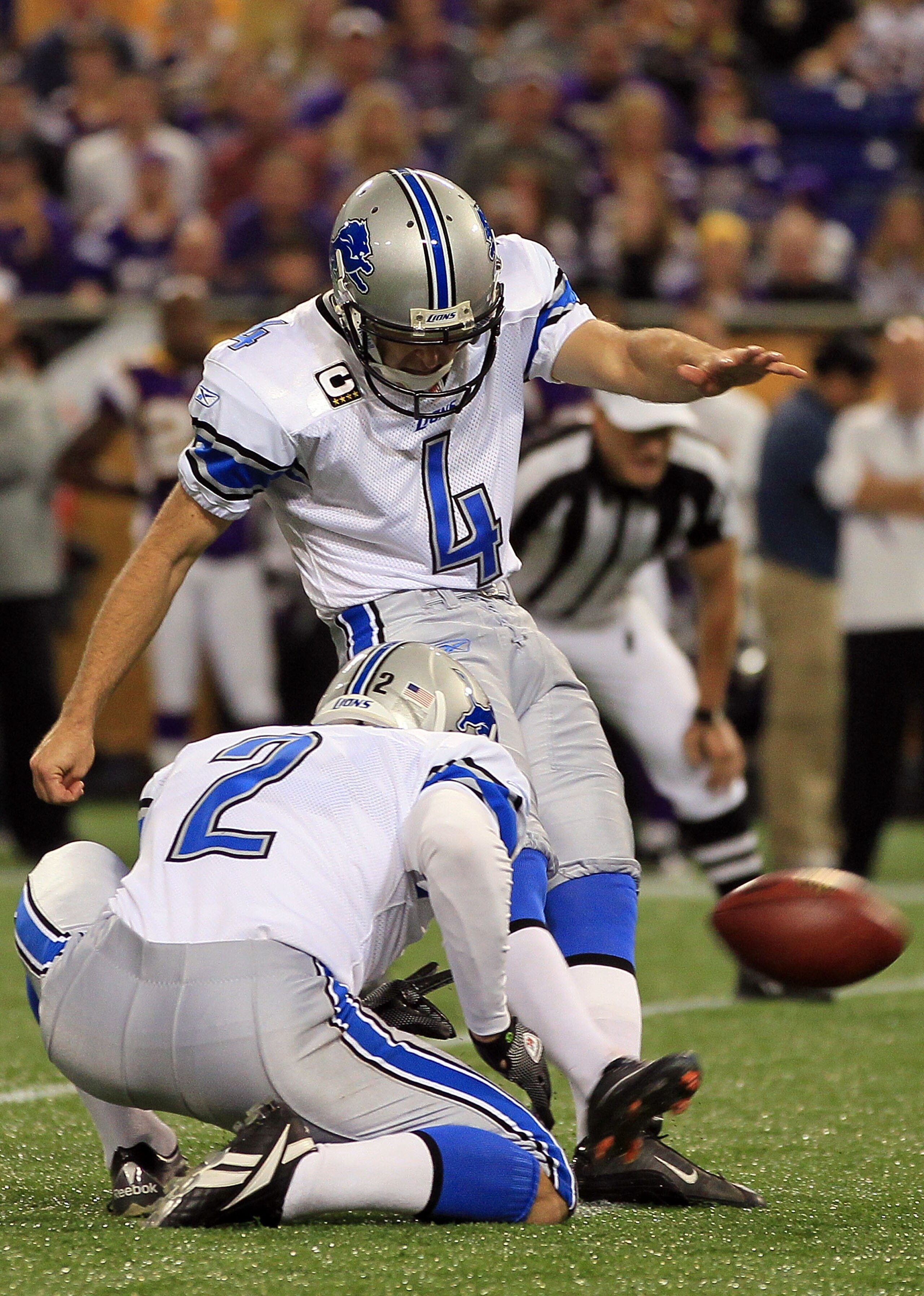 MINNEAPOLIS - SEPTEMBER 26:  Kicker Jason Hanson #4 of the Detroit Lions kicks as place kicker Nick Harris #2 holds against the Minnesota Vikings at Mall of America Field on September 26, 2010 in Minneapolis, Minnesota.  (Photo by Jeff Gross/Getty Images)