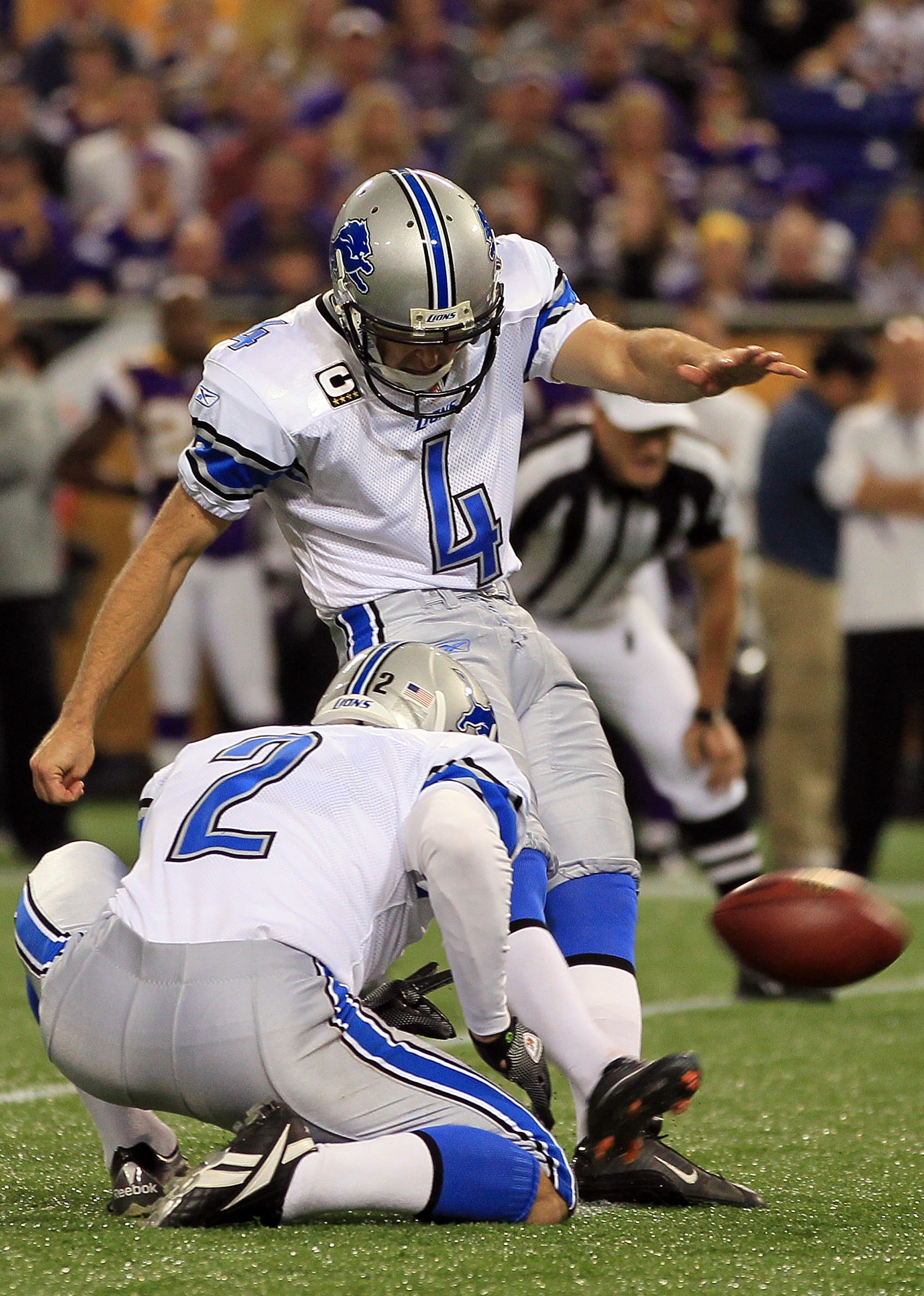 MINNEAPOLIS - SEPTEMBER 26:  Kicker Jason Hanson #4 of the Detroit Lions kicks as place kicker Nick Harris #2 holds against the Minnesota Vikings at Mall of America Field on September 26, 2010 in Minneapolis, Minnesota.  (Photo by Jeff Gross/Getty Images)