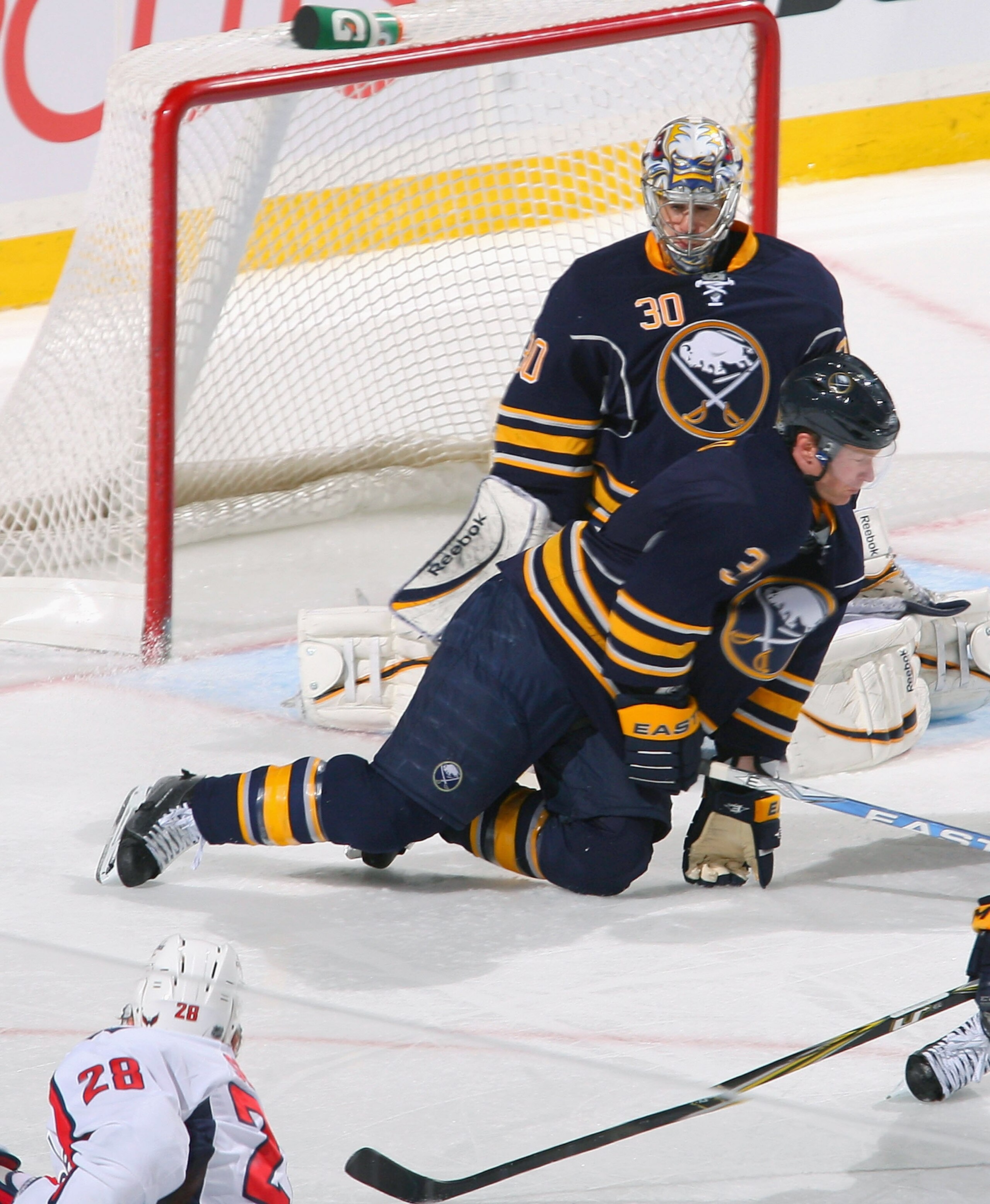 BUFFALO, NY - FEBRUARY 20: Jordan Leopold #3 of the Buffalo Sabres goes down to block a shot in front of Ryan Miller #30 taken by Alexander Semin #28 of the Washington Capitals at HSBC Arena on February 20, 2011 in Buffalo, New York.  (Photo by Rick Stewa