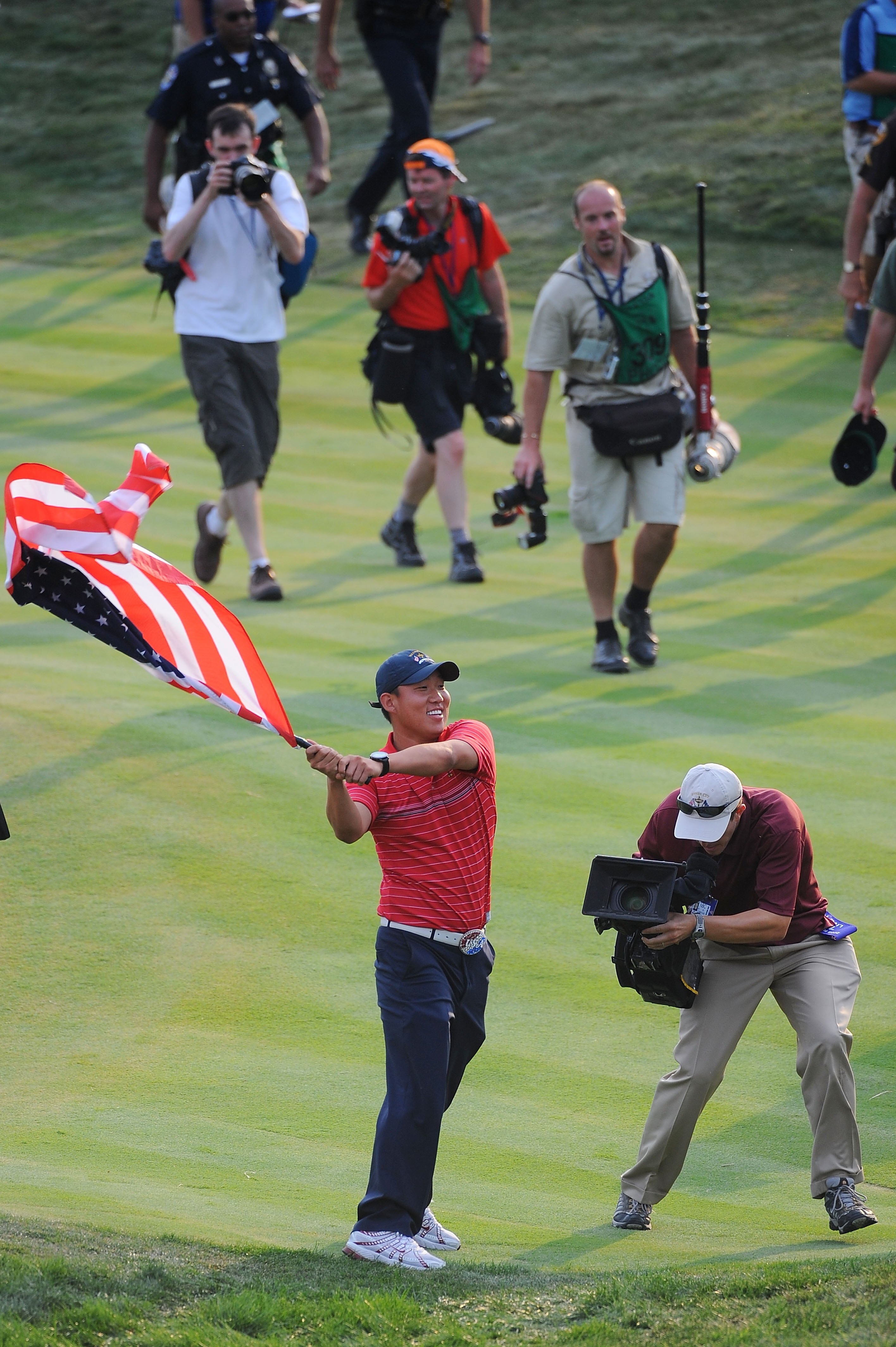 LOUISVILLE, KY - SEPTEMBER 21:  Anthony Kim of the USA team holds an American flag as he celebrates the USA 16 1/2 - 11 1/2 victory on the final day of the 2008 Ryder Cup at Valhalla Golf Club on September 21, 2008 in Louisville, Kentucky.  (Photo by Sam
