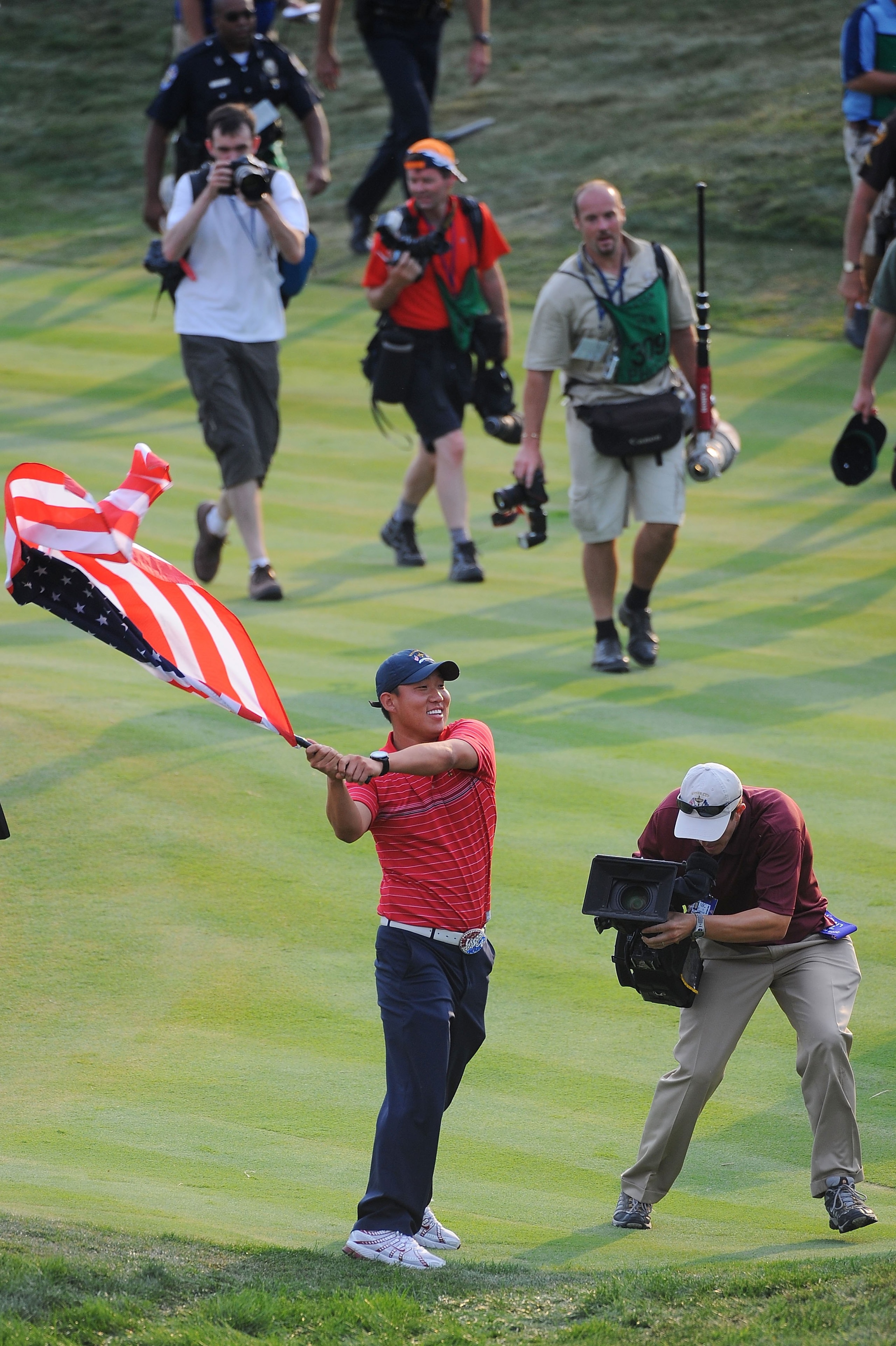 LOUISVILLE, KY - SEPTEMBER 21:  Anthony Kim of the USA team holds an American flag as he celebrates the USA 16 1/2 - 11 1/2 victory on the final day of the 2008 Ryder Cup at Valhalla Golf Club on September 21, 2008 in Louisville, Kentucky.  (Photo by Sam