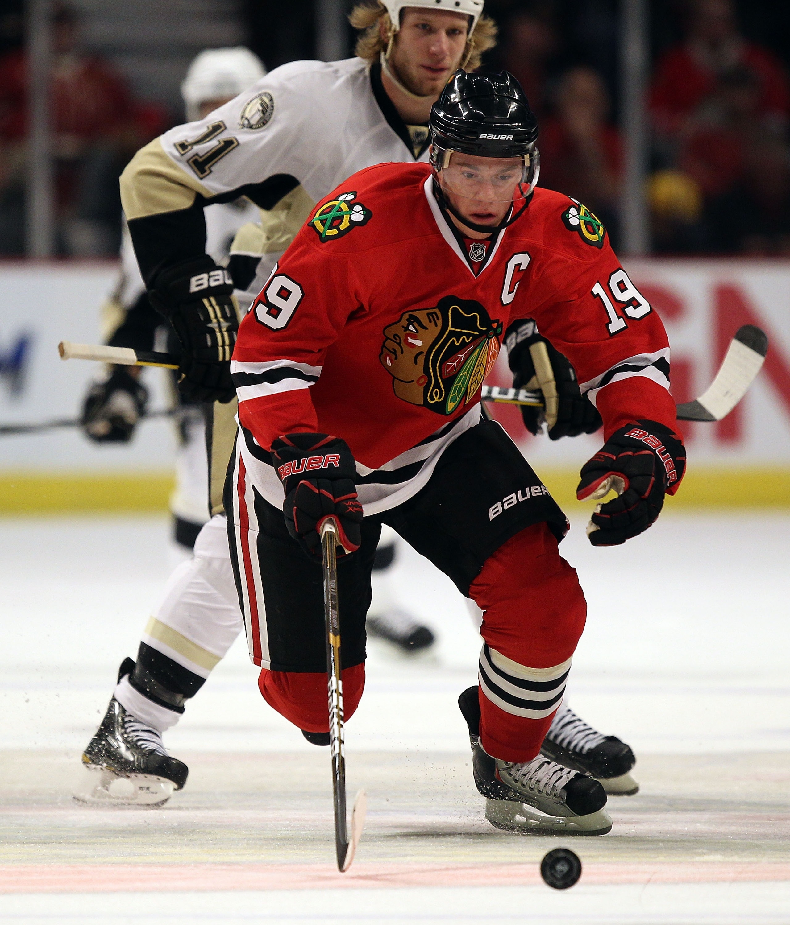 CHICAGO, IL - FEBRUARY 20: Jonathan Toews #19 of the Chicago Blackhawks chases down the puck in front of Jordan Staal #11 of the Pittsburgh Penguins at the United Center on February 20, 2011 in Chicago, Illinois. (Photo by Jonathan Daniel/Getty Images)