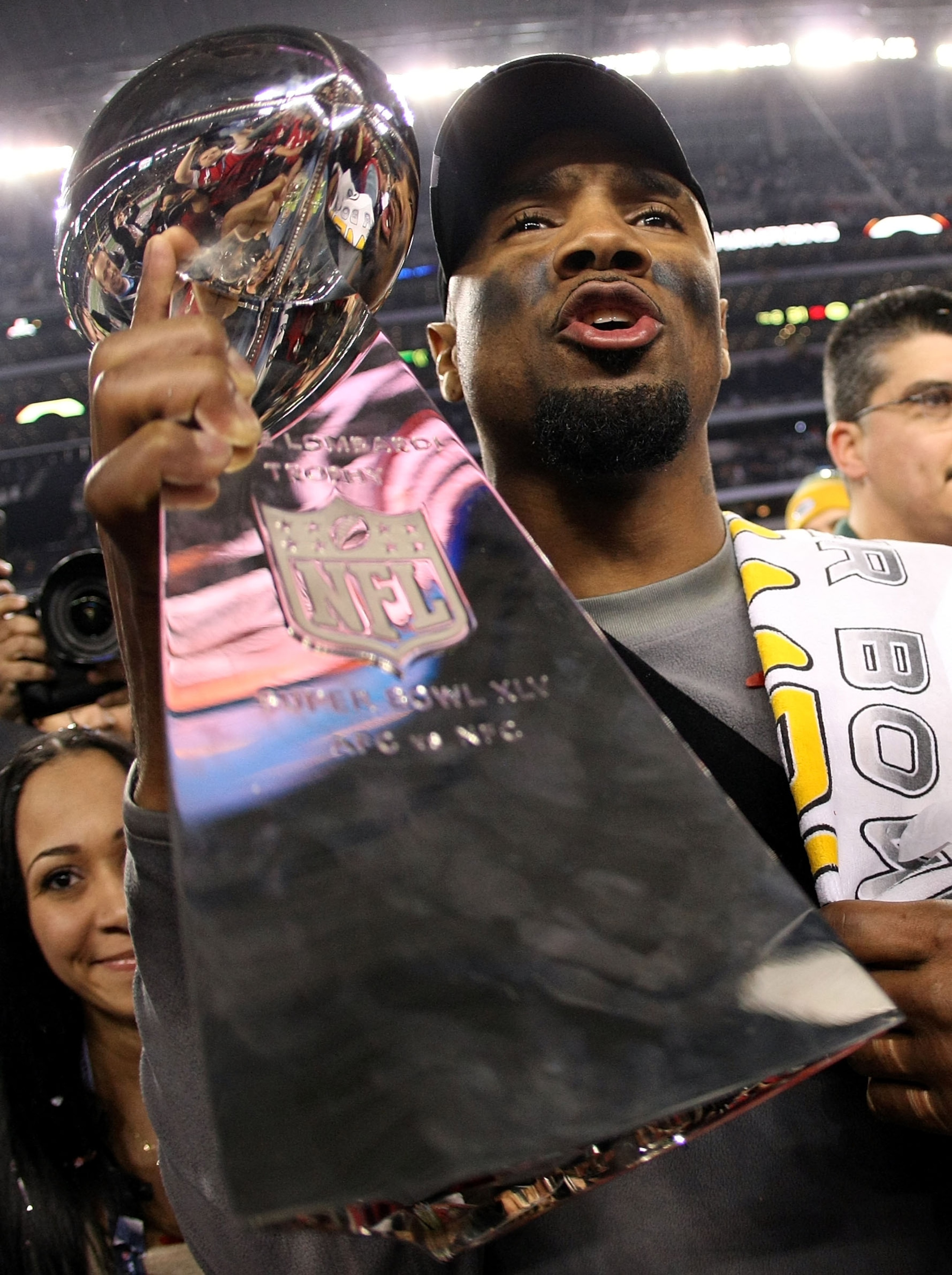 ARLINGTON, TX - FEBRUARY 06:  Charles Woodson #21 of the Green Bay Packers, who was injured during the game, celebrates with the Vince Lombardi Trophy after they defeated the Pittsburgh Steelers 31 to 25 in Super Bowl XLV at Cowboys Stadium on February 6,