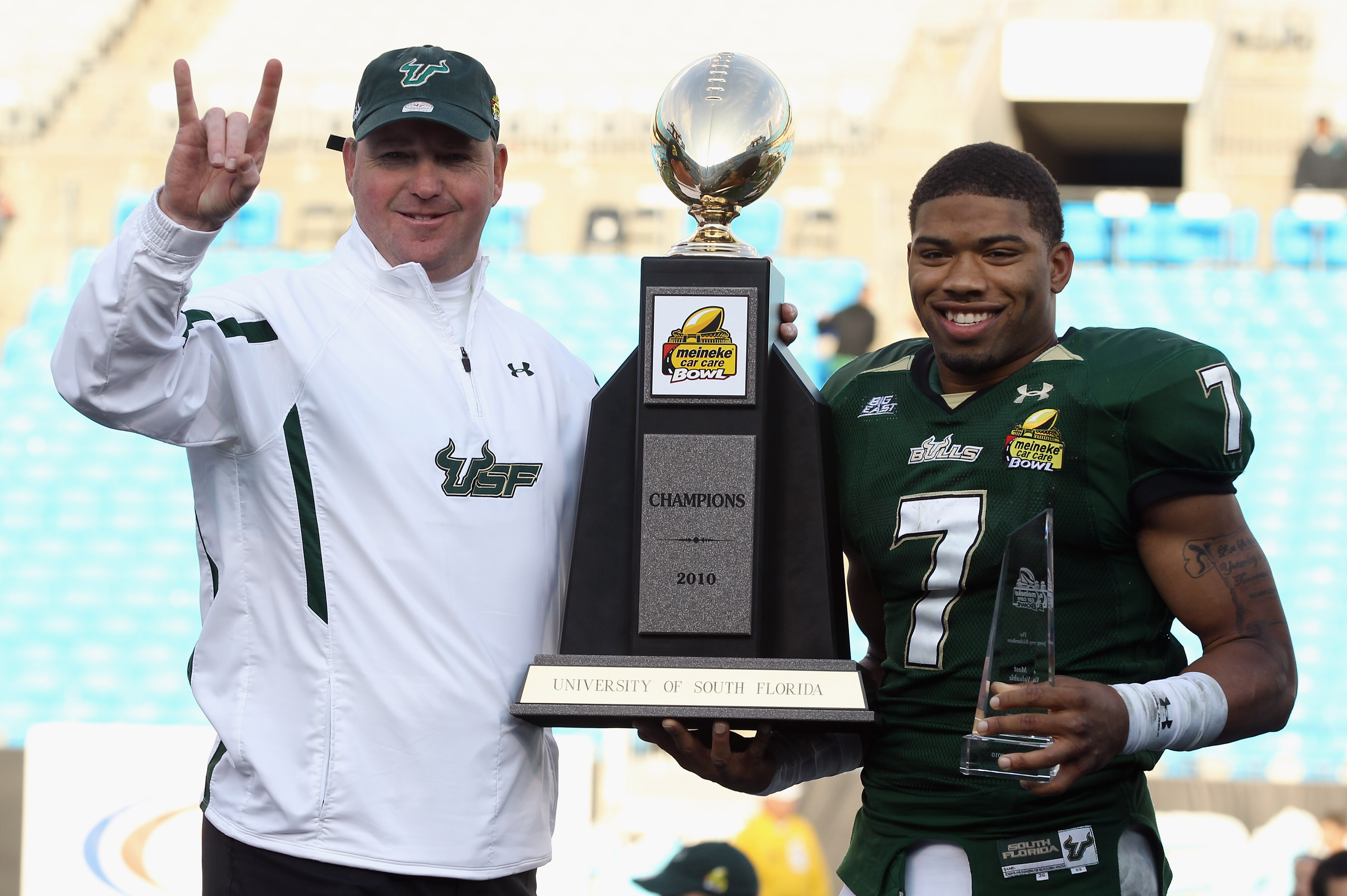 CHARLOTTE, NC - DECEMBER 31: Head coach Skip Holtz stands with MVP B.J. Daniels #7 of the USF Bulls after a 31-26 victory over the Clemson Tigers at Bank of America Stadium on December 31, 2010 in Charlotte, North Carolina. (Photo by Streeter Lecka/Gett