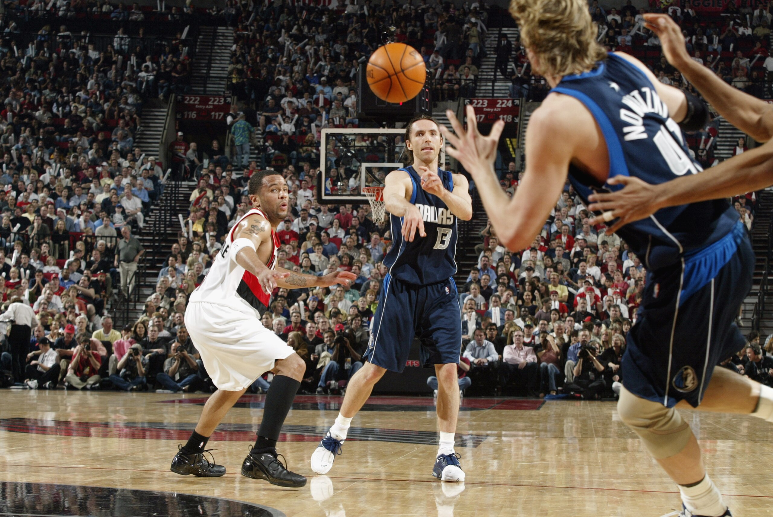 PORTLAND, OR - MAY 2:  Steve Nash #13 of the Dallas Mavericks passes to teammate Dirk Nowitzki #41 in Game six of the Western Conference Quarterfinals during the 2003 NBA Playoffs against the Portland Trail Blazers at The Rose Garden on May 2, 2003 in Por