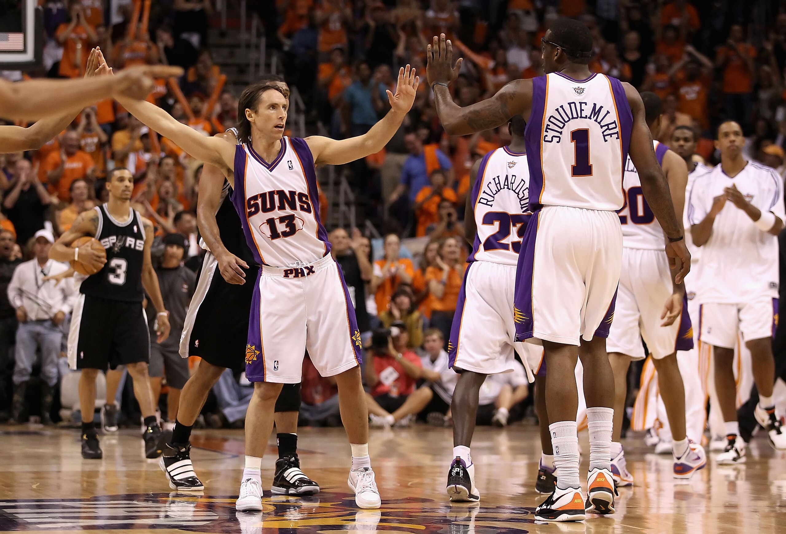 PHOENIX - MAY 03:  Steve Nash #13 of the Phoenix Suns high fives teammate Amar'e Stoudemire #1 after scoring against the San Antonio Spurs during Game One of the Western Conference Semifinals of the 2010 NBA Playoffs at US Airways Center on May 3, 2010 in