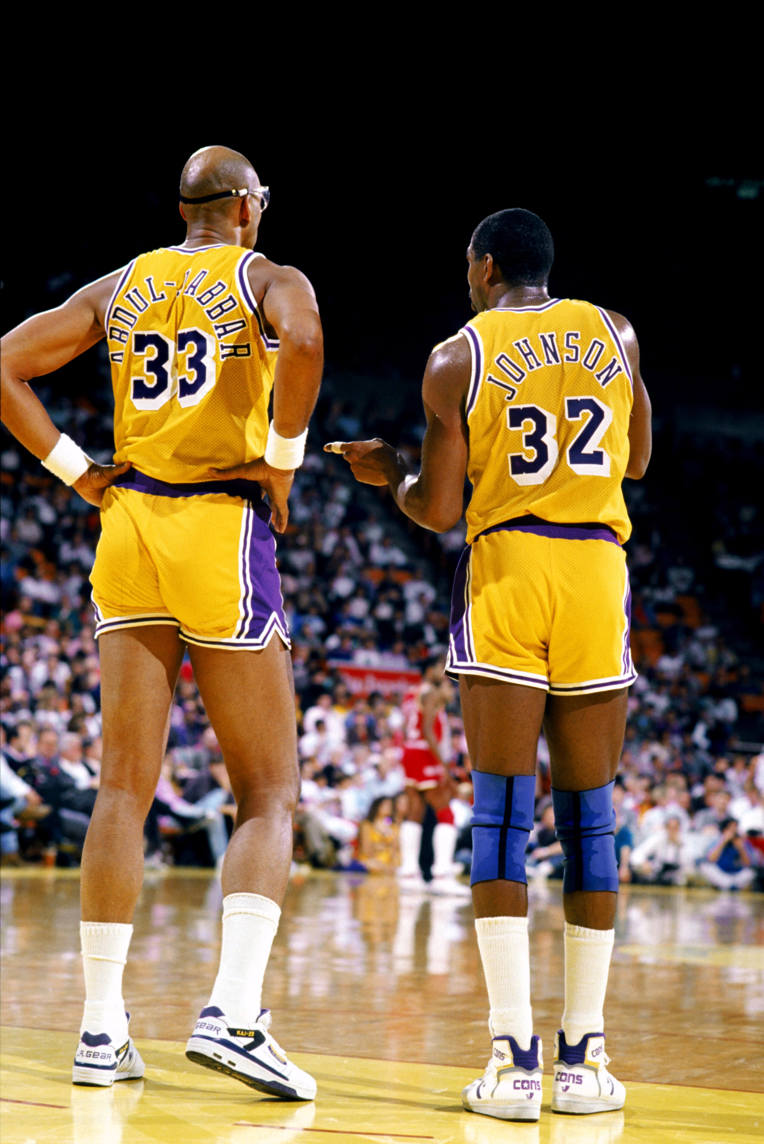 LOS ANGELES - 1988:  Kareem Abdul-Jabbar #33 of the Los Angeles Lakers listens to Magic Johnson #32 during an NBA game at the Great Western Forum in Los Angeles, California in 1988. (Photo by Mike Powell/Getty Images)