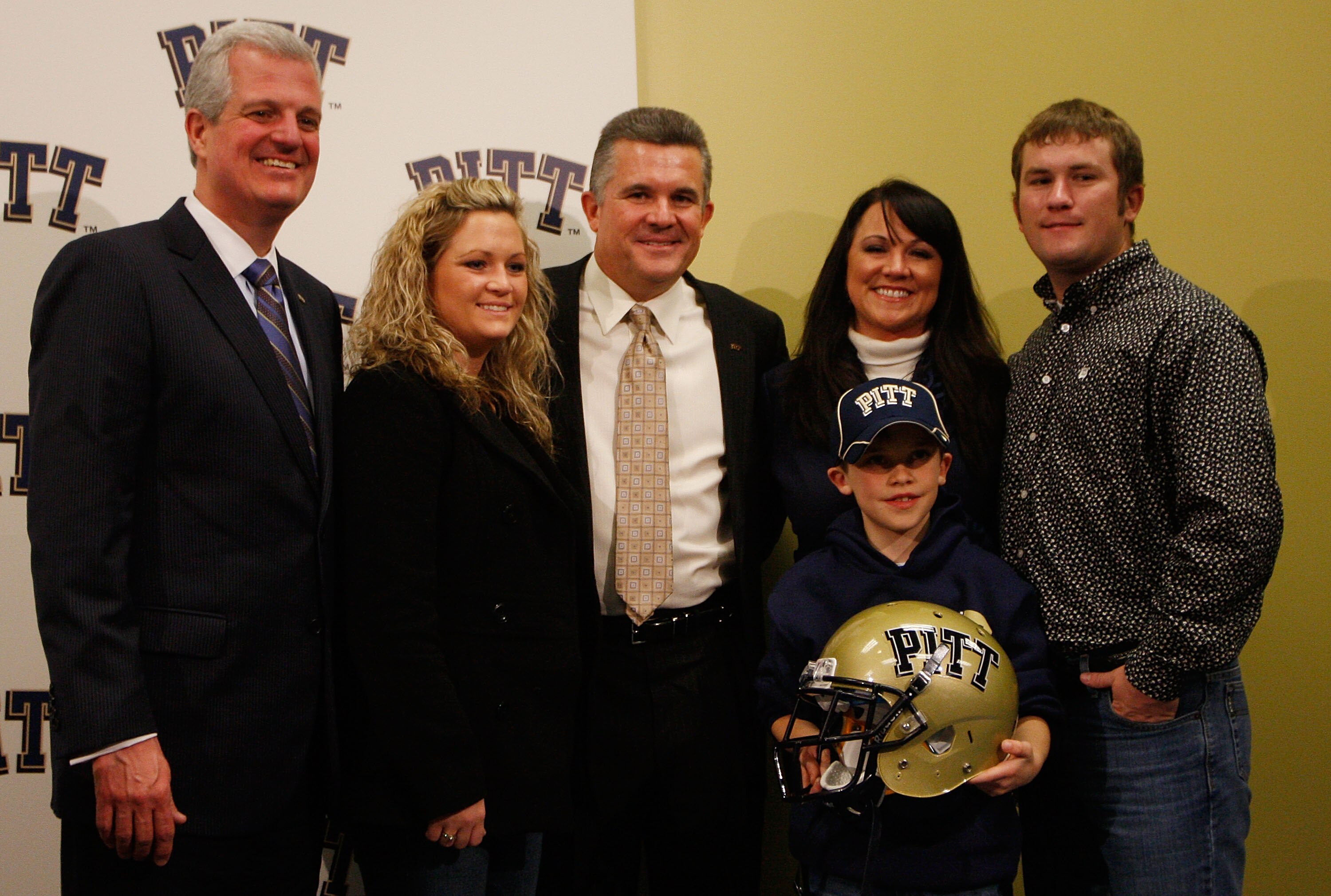 PITTSBURGH - JANUARY 11:  The new University of Pittsburgh head football coach, Todd Graham (center), poses for a photograph with members of his family and University of Pittsburgh athletic director, Steve Pederson (far left), during a press conference on