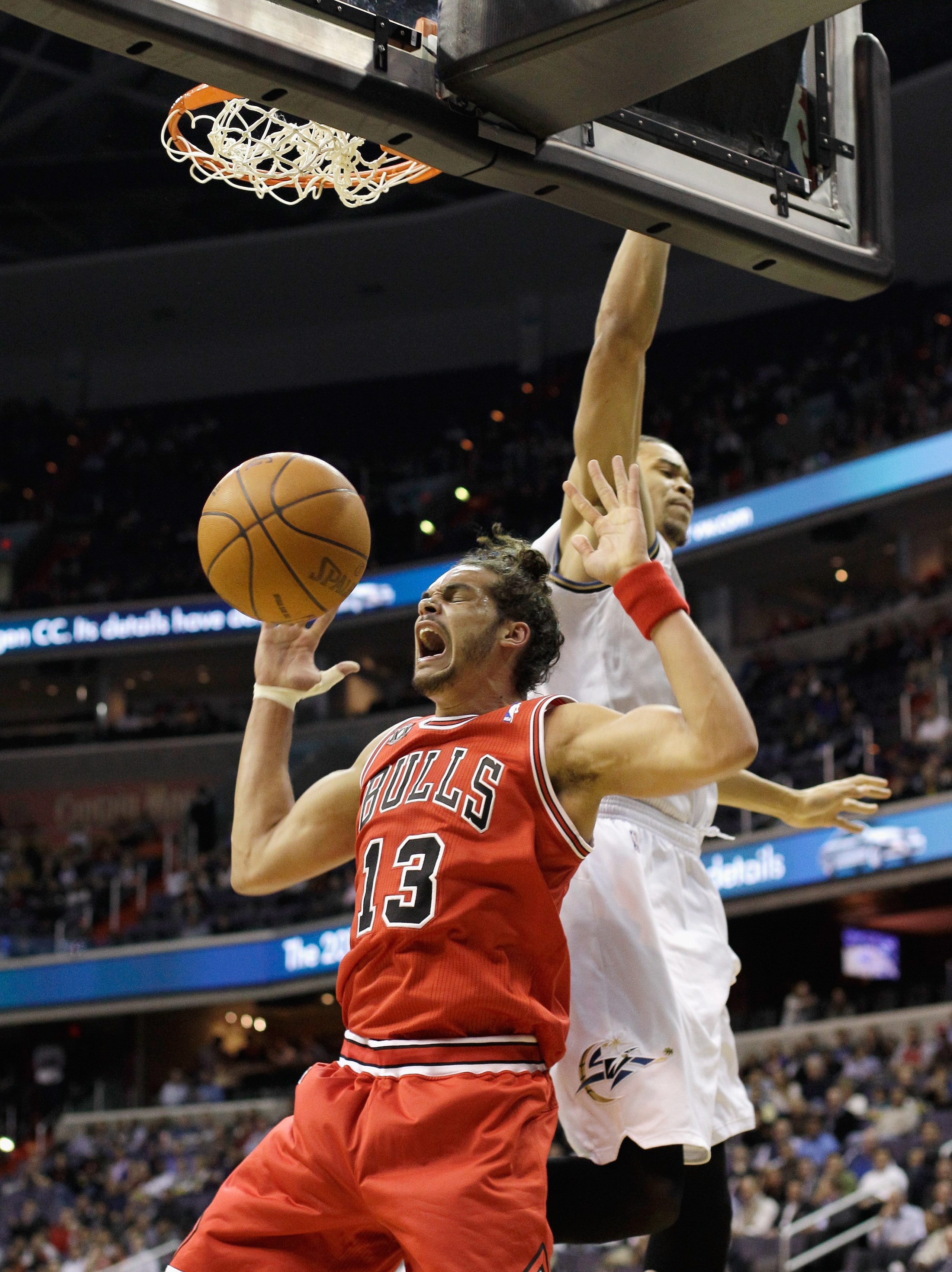 WASHINGTON, DC - FEBRUARY 28: Joakim Noah #13 of the Chicago Bulls dunks in front of JaVale McGee #34 of the Washington Wizards during the frist half at the Verizon Center in Washington on February 28, 2011 in Washington, DC. NOTE TO USER: User expressly WASHINGTON, DC - FEBRUARY 28: Joakim Noah #13 of the Chicago Bulls dunks in front of JaVale McGee #34 of the Washington Wizards during the frist half at the Verizon Center in Washington on February 28, 2011 in Washington, DC. NOTE TO USER: User expressly