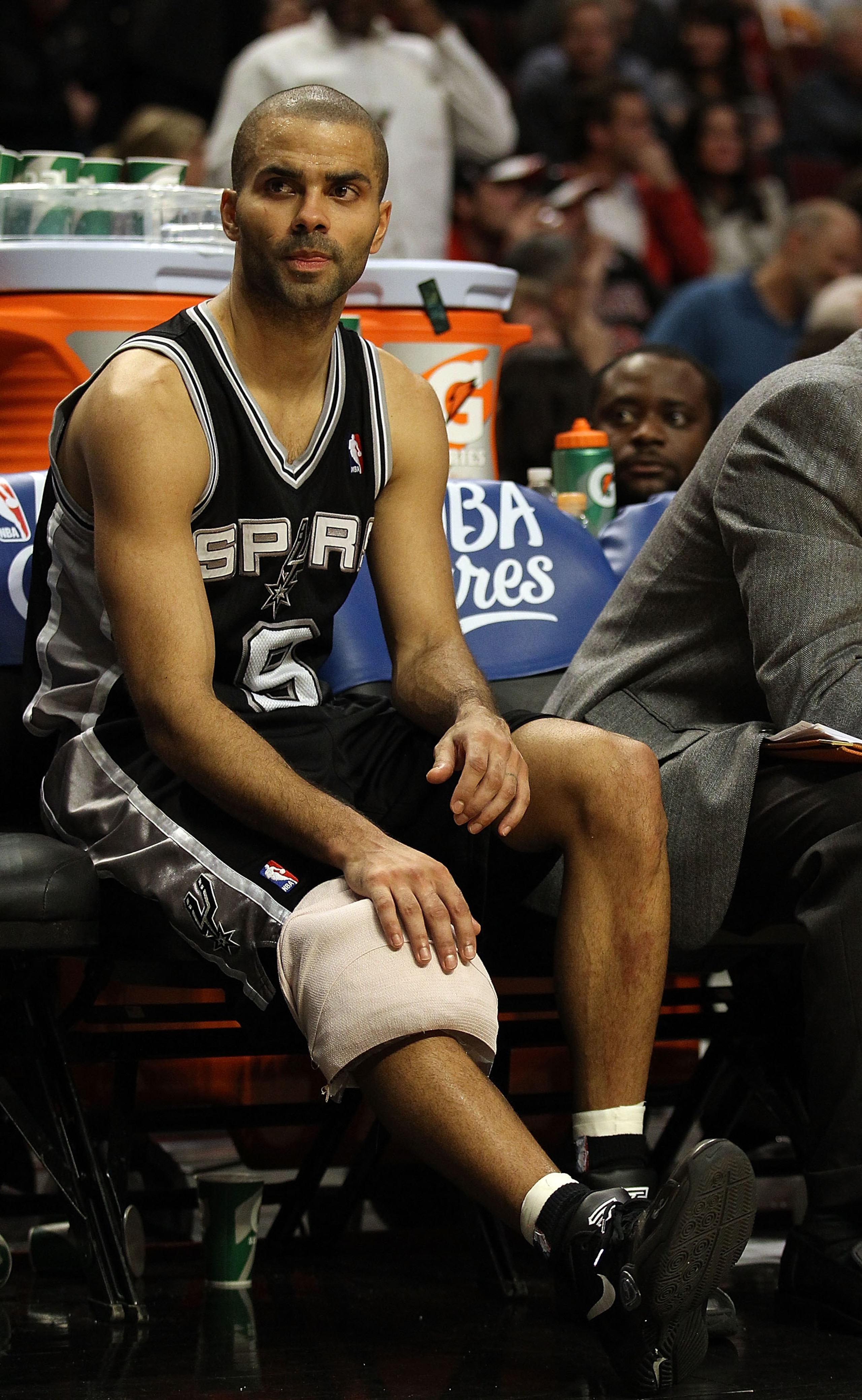 CHICAGO, IL - FEBRUARY 17: Tony Parker #9 of the San Antonio Spurs sits on the bench with a knee injury near the end of a game against the Chicago Bulls at the United Center on February 17, 2011 in Chicago, Illinois. The Bulls defeated the Spurs 109-99. N