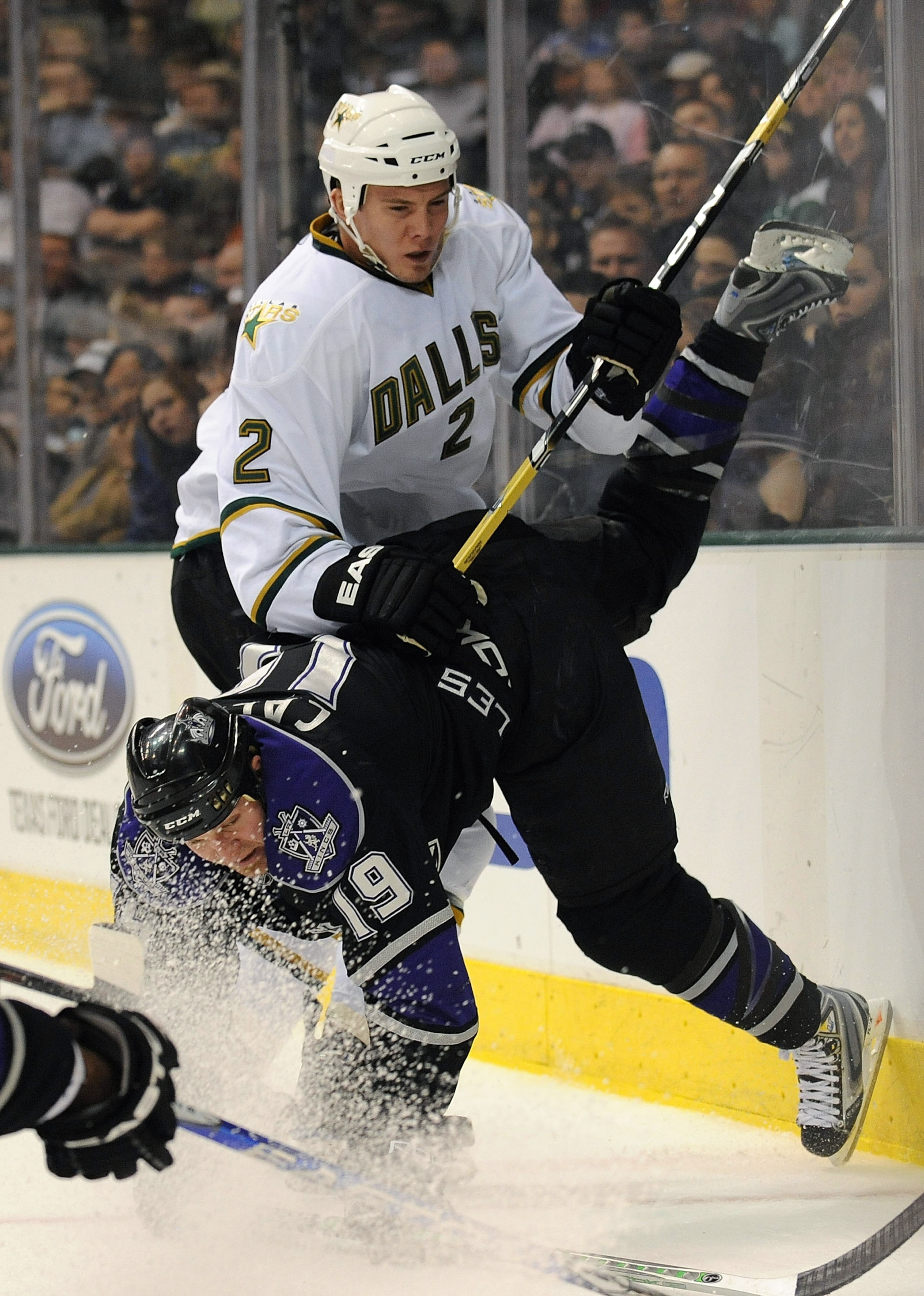 DALLAS - JANUARY 17:  Defenseman Nicklas Grossman #2 of the Dallas Stars checks Kyle Calder #19 of the Los Angeles Kings in the second period at the American Airlines Center on January 17, 2009 in Dallas, Texas.  (Photo by Ronald Martinez/Getty Images)