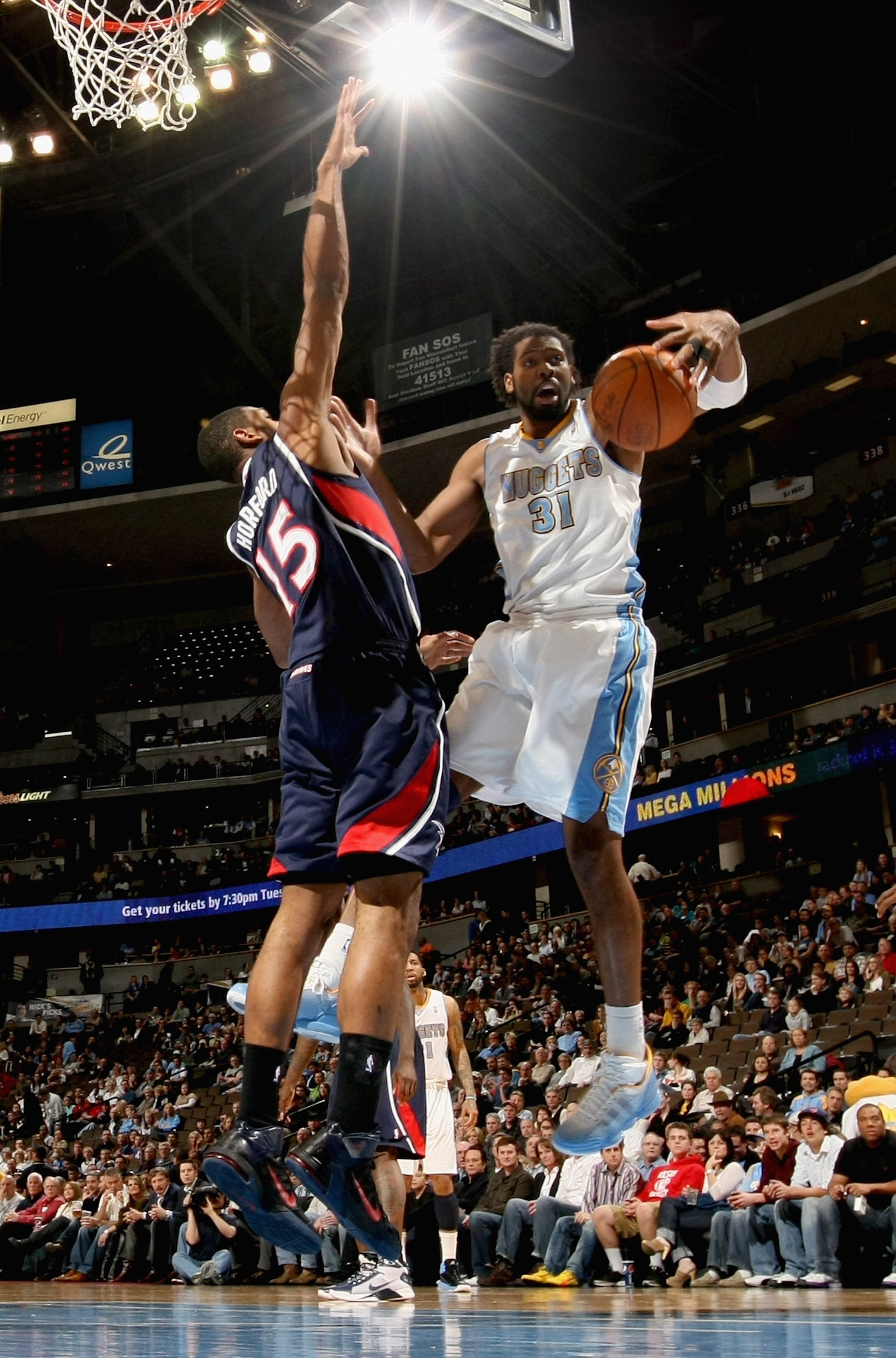 DENVER, CO - FEBRUARY 28:  Nene #31 of the Denver Nuggets grabs a rebound away from Al Horford #15 of the Atlanta Hawksl during NBA action at the Pepsi Center on February 28, 2011 in Denver, Colorado. The Nuggets deafeated the Hawks 100-90. NOTE TO USER: