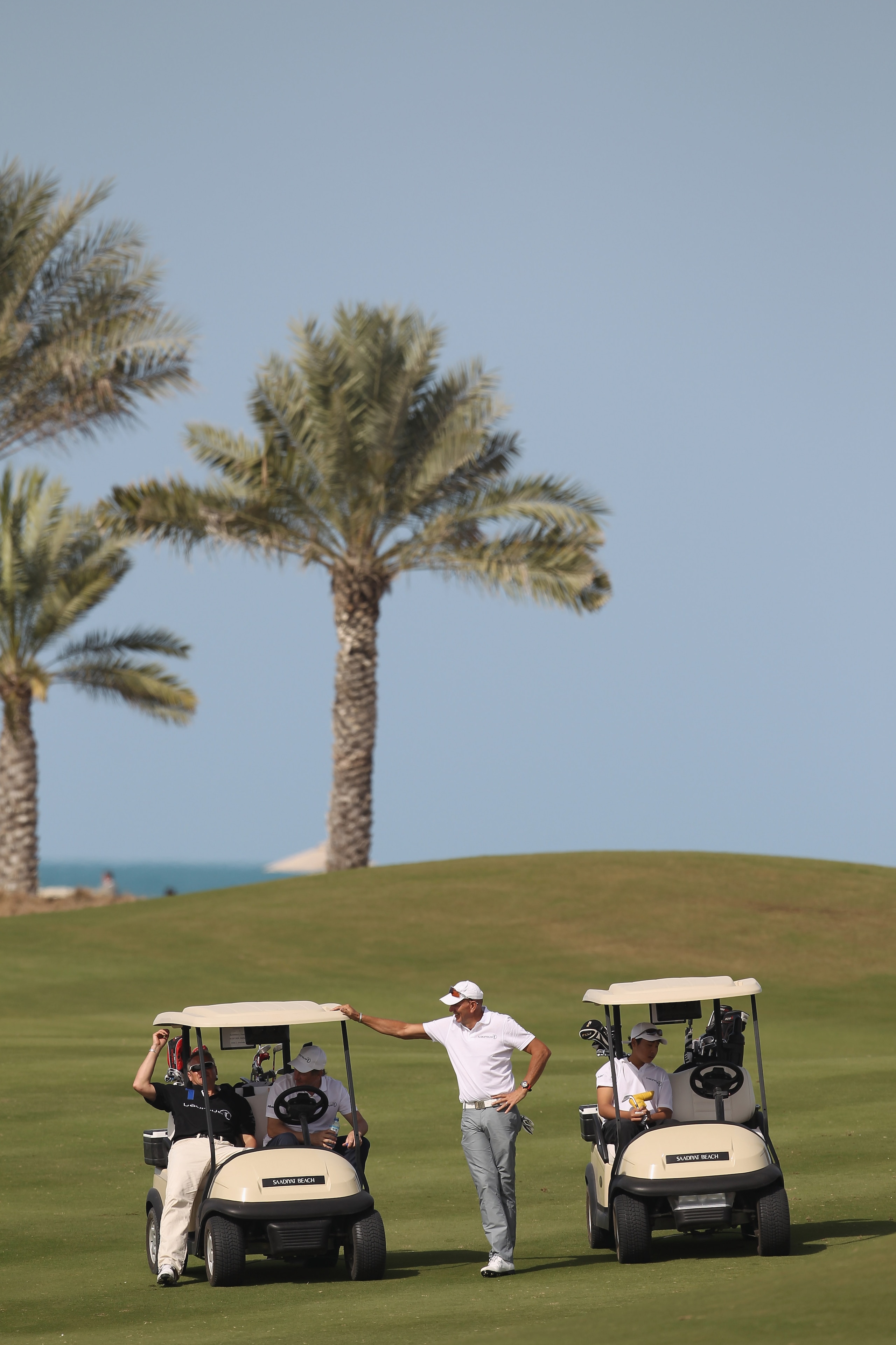 ABU DHABI, UNITED ARAB EMIRATES - FEBRUARY 06:  Academy Member Franz Klammer (Left cart) and Stefan Bloecher relax during the Laureus Golf Challenge at the Saadiyat Beach Golf Club part of the 2011 Laureus World Sports Awards on February 6, 2011 in Abu Dh