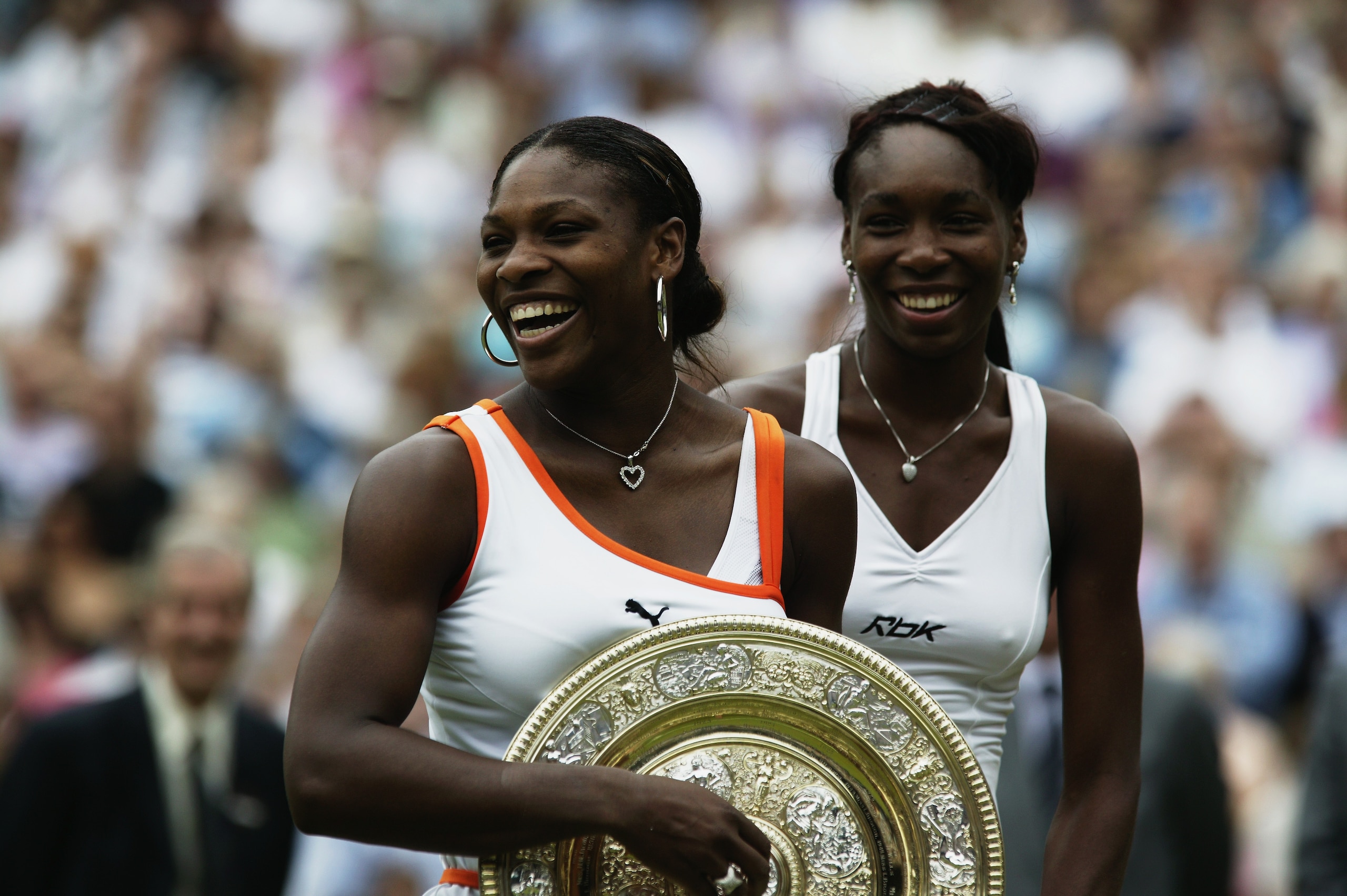 LONDON - JULY 5:  Serena Williams of the USA celebrates victory by holding the trophy after her match against sister Venus Williams of the USA in the Womens Singles Final during day twelve of the Wimbledon Lawn Tennis Championships held on July 5, 2003 at