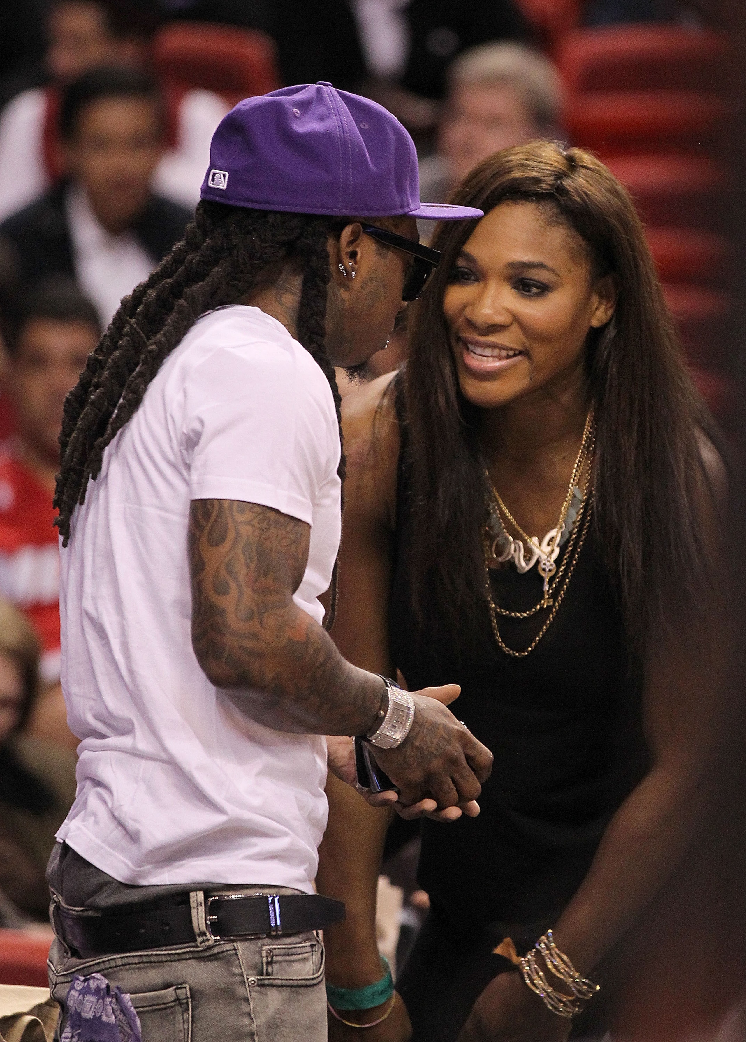 MIAMI, FL - DECEMBER 01:  Tennis star Serena Williams talks with Rapper Lil' Wayne during a game between the Miami Heat  and the Detroit Pistons at American Airlines Arena on December 1, 2010 in Miami, Florida. NOTE TO USER: User expressly acknowledges an