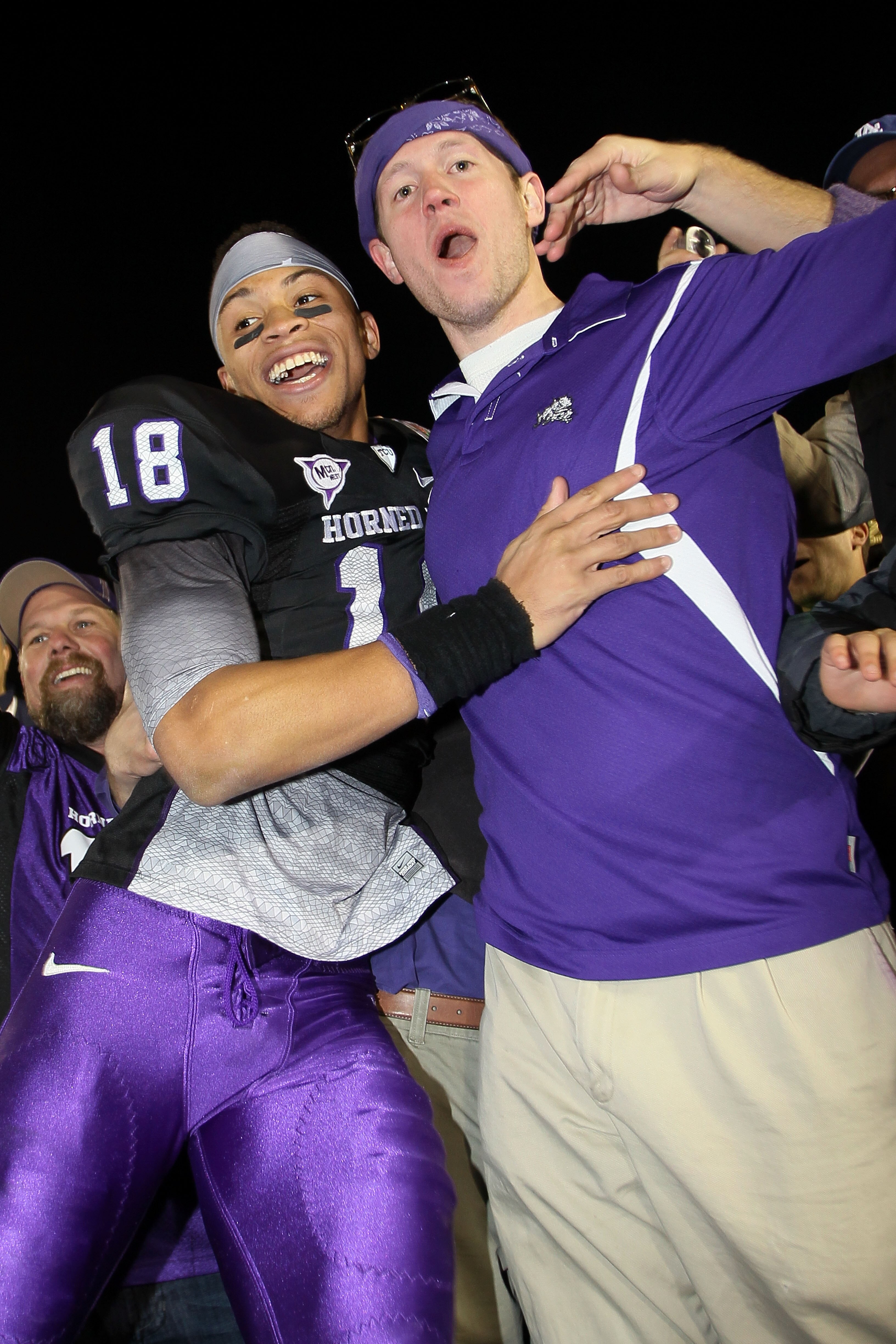 PASADENA, CA - JANUARY 01:  Cornerback Travaras Battle #18 of the TCU Horned Frogs celebrates with a fan after defeating the Wisconsin Badgers 21-19 in the 97th Rose Bowl game on January 1, 2011 in Pasadena, California.  (Photo by Stephen Dunn/Getty Image