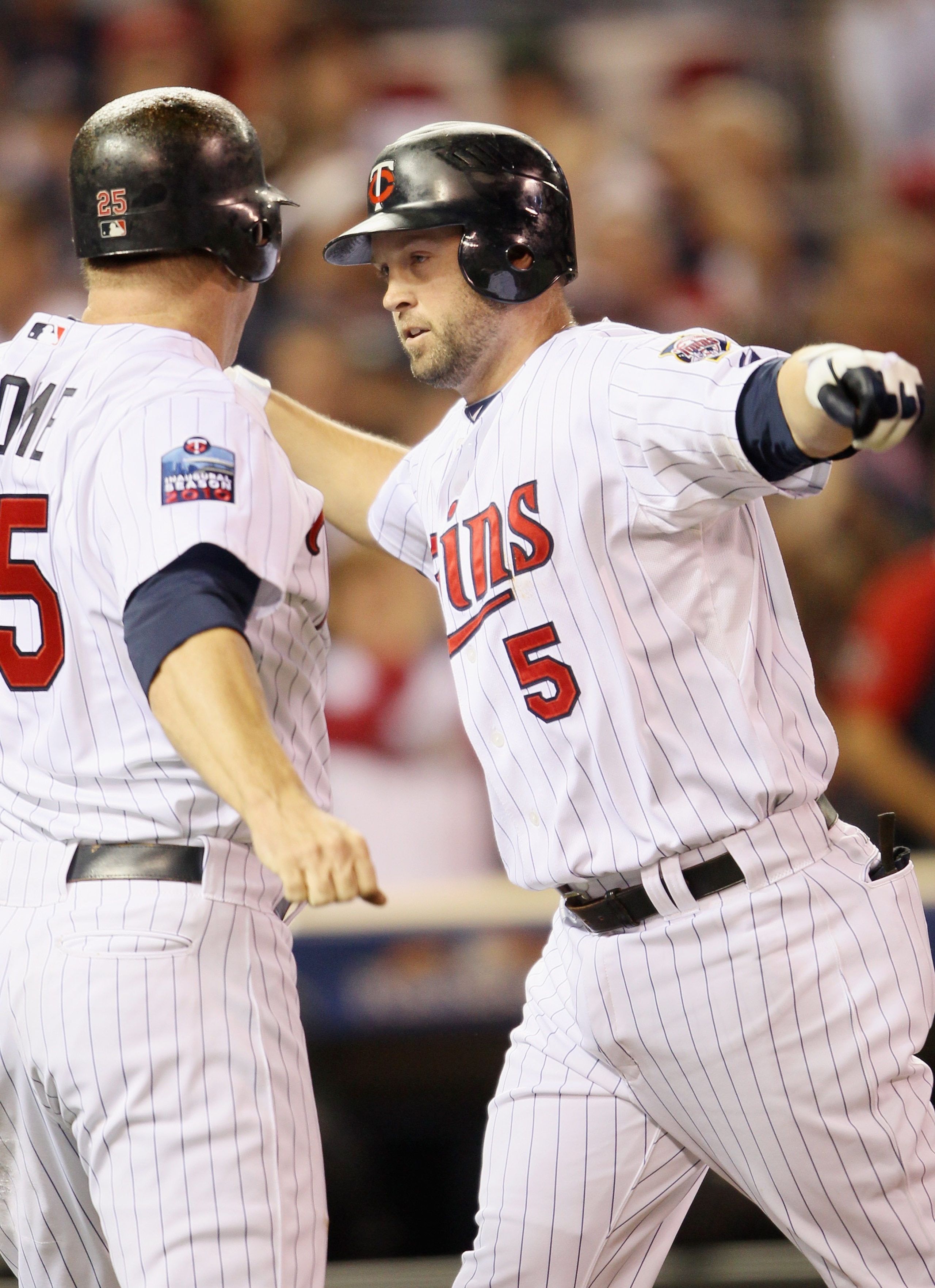 MINNEAPOLIS - OCTOBER 06: Michael Cuddyer #5 of the Minnesota Twins celebrates his two run homer with teammate Jim Thome #25 in the second inning agianst the New York Yankees during game one of the ALDS on October 6, 2010 at Target Field in Minneapolis, MINNEAPOLIS - OCTOBER 06: Michael Cuddyer #5 of the Minnesota Twins celebrates his two run homer with teammate Jim Thome #25 in the second inning agianst the New York Yankees during game one of the ALDS on October 6, 2010 at Target Field in Minneapolis,