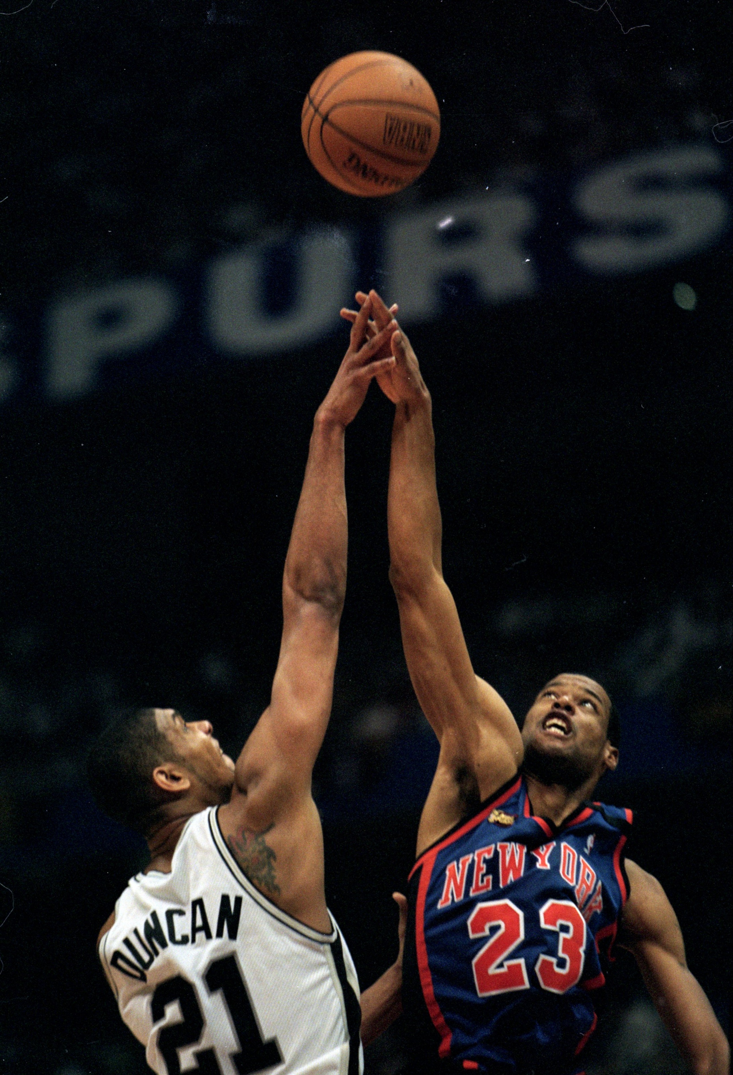 18 Jun 1999: Marcus Camby #23 of the New York Knicks jumps to tip the ball away from Tim Duncan #21 of San Antonio Spurs during the NBA Finals game two at the AlamoDome in San Antonio, Texas. The Spurs defeated the Knicks 80-67.   Mandatory Credit: Todd W