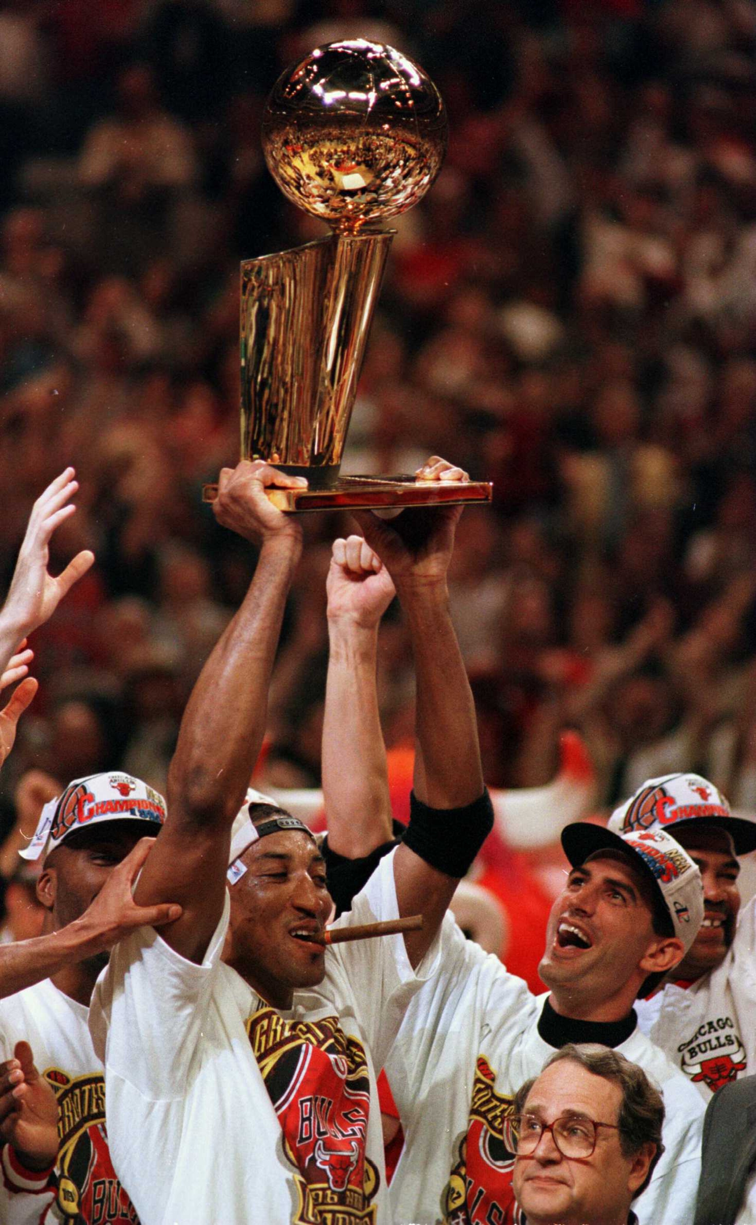 16 Jun 1996: Chicago Bull Scottie Pippen hoists the NBA Championship trophy at end of game six of the NBA Finals at the United Center in Chicago, Illinois. The Bulls went on to defeat the Seattle Supersonics 87-75 to win the 1996 NBA Finals.  Mandatory Cr