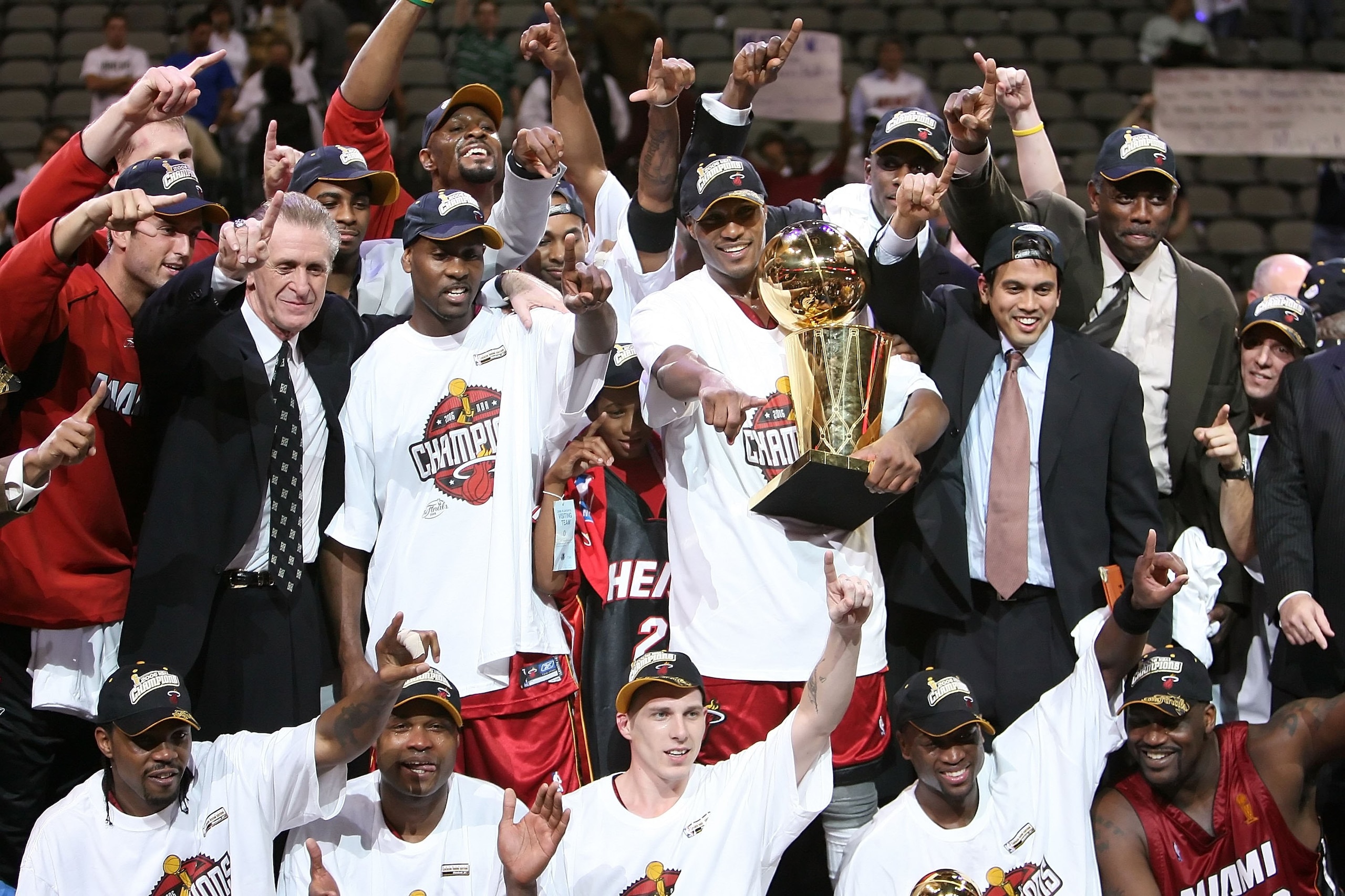 DALLAS - JUNE 20:  The Miami Heat celebrate as they receive the Larry O'Brien trophy after the Heat defeated the Dallas Mavericks in game six of the 2006 NBA Finals on June 20, 2006 at American Airlines Center in Dallas, Texas.  The Heat won 95-92 and win