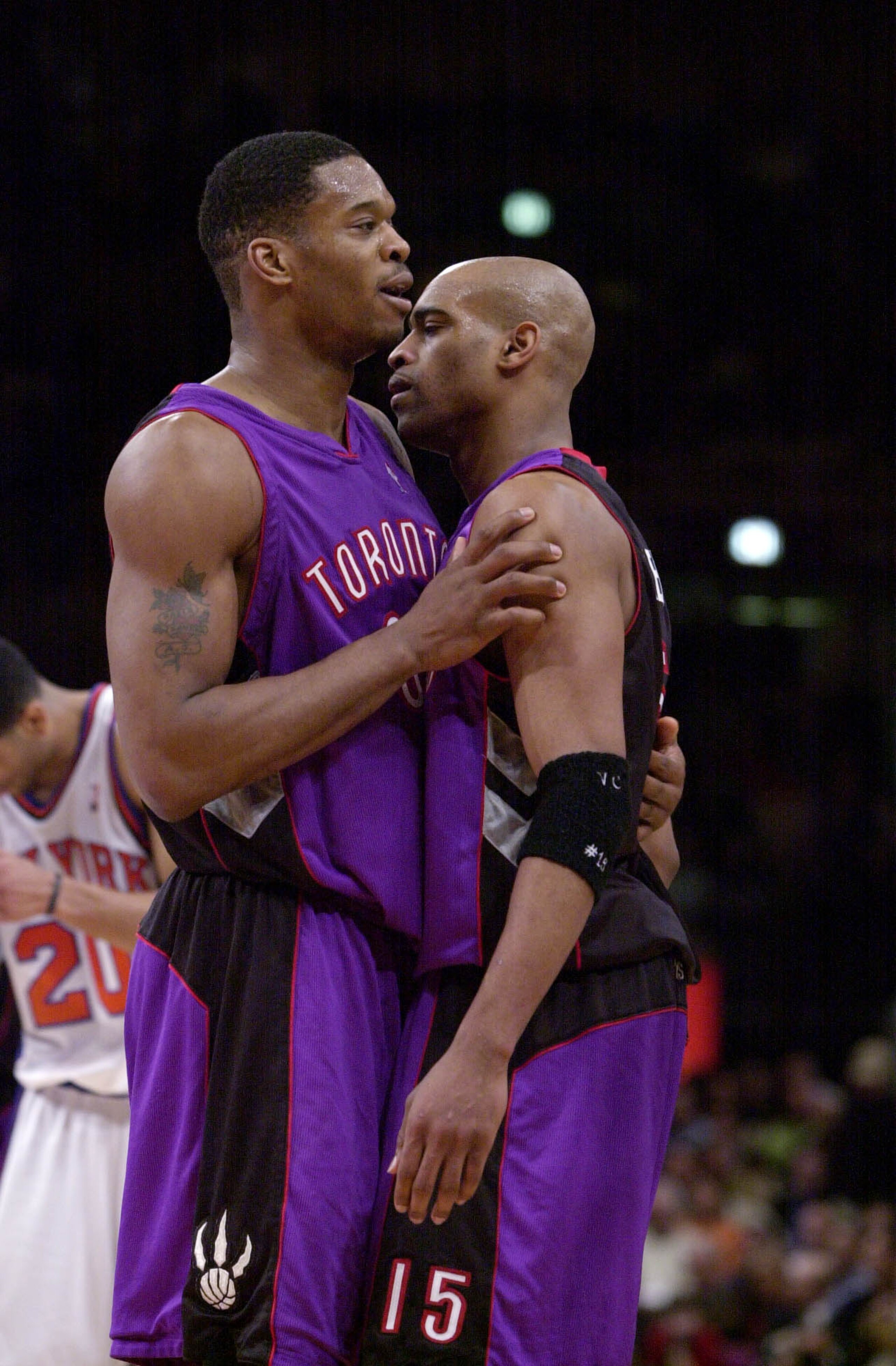 26 Apr 2001: Vince Carter #15 of the Toronto Raptors celebrates with Antonio Davis #33 after winning game two of the NBA Playoffs against the New York Knicks at Madison Square Garden in New York, New York.  The Raptors won 94-74.  DIGITAL IMAGE.  Mandator