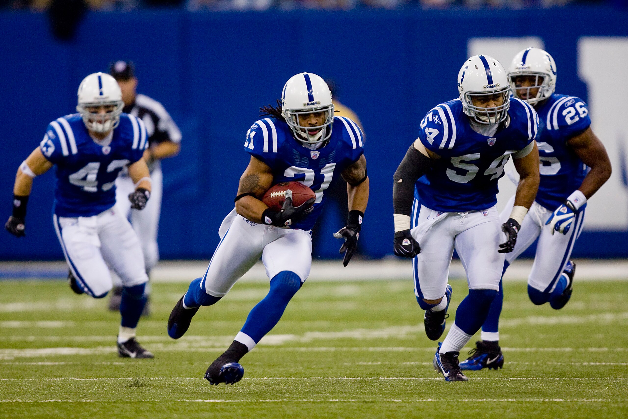 INDIANAPOLIS, IN - DECEMBER 23: Bob Sanders #21 of the Indianapolis Colts returns an interception against the Houston Texans with teammates Matt Giordano #43, Freddy Keiaho#54 and Kelvin Hayden #26  on December 23, 2007 at the RCA Dome in Indianapolis, In