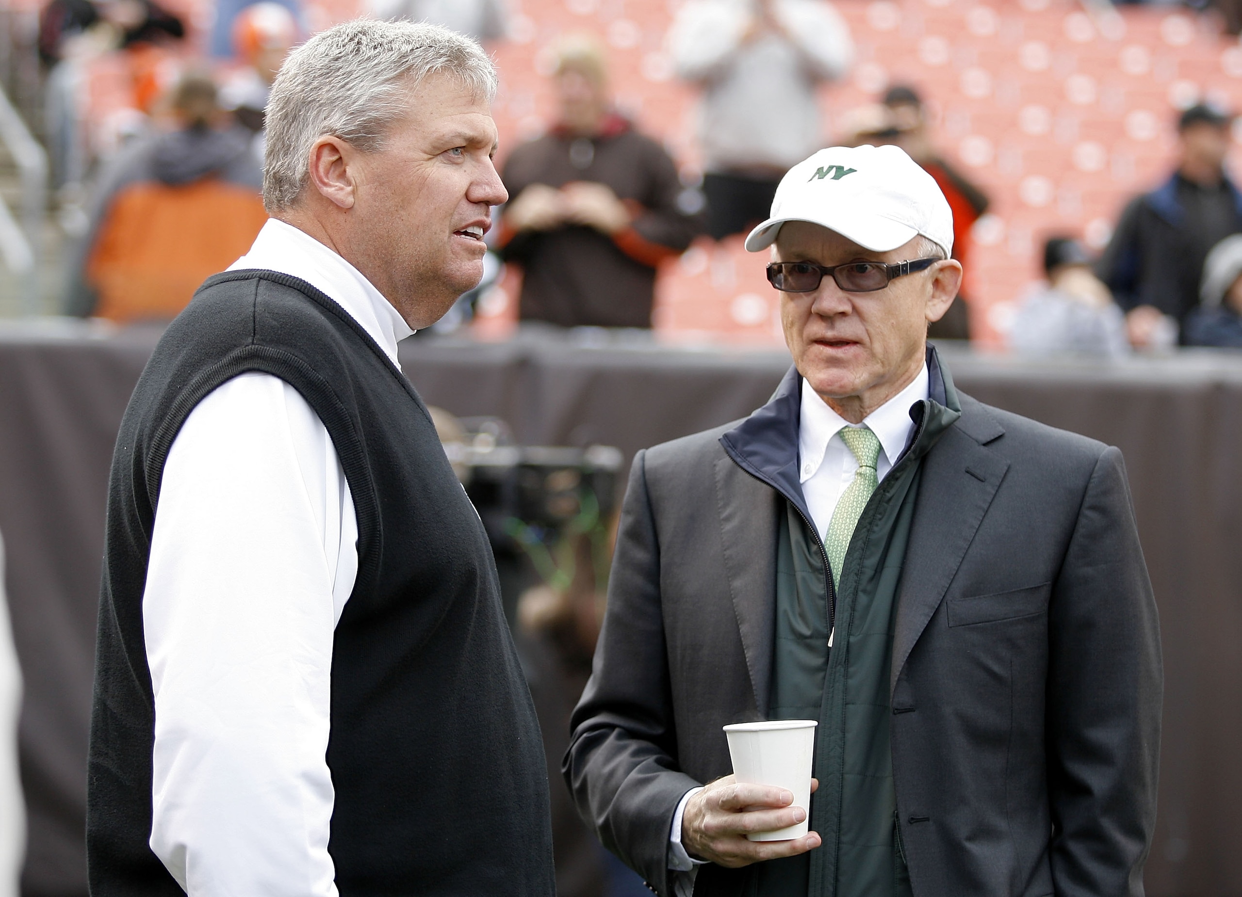 CLEVELAND - NOVEMBER 14:  Head coach Rex Ryan (L) of the New York Jets talks with owner Woody Johnson prior to the start of their game against the Cleveland Browns at Cleveland Browns Stadium on November 14, 2010 in Cleveland, Ohio.  (Photo by Matt Sulliv