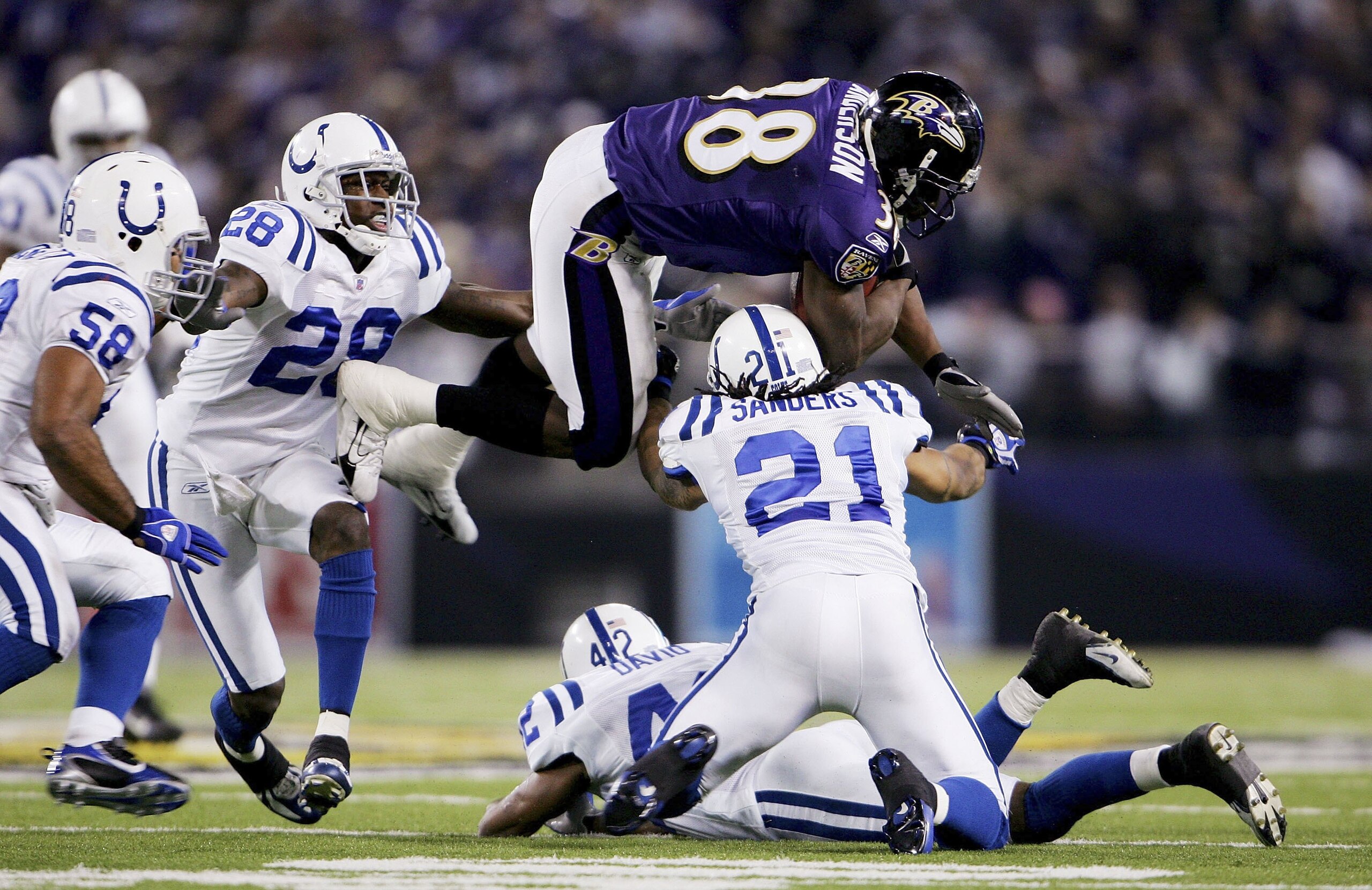 BALTIMORE - JANUARY 13:  Mike Anderson #38 of the Baltimore Ravens flies over the top of Bob Sanders #21 of the Indianapolis Colts during their AFC Divisional Playoff game on January 13, 2007 at M&T Bank Stadium in Baltimore, Maryland.  (Photo by Chris Mc