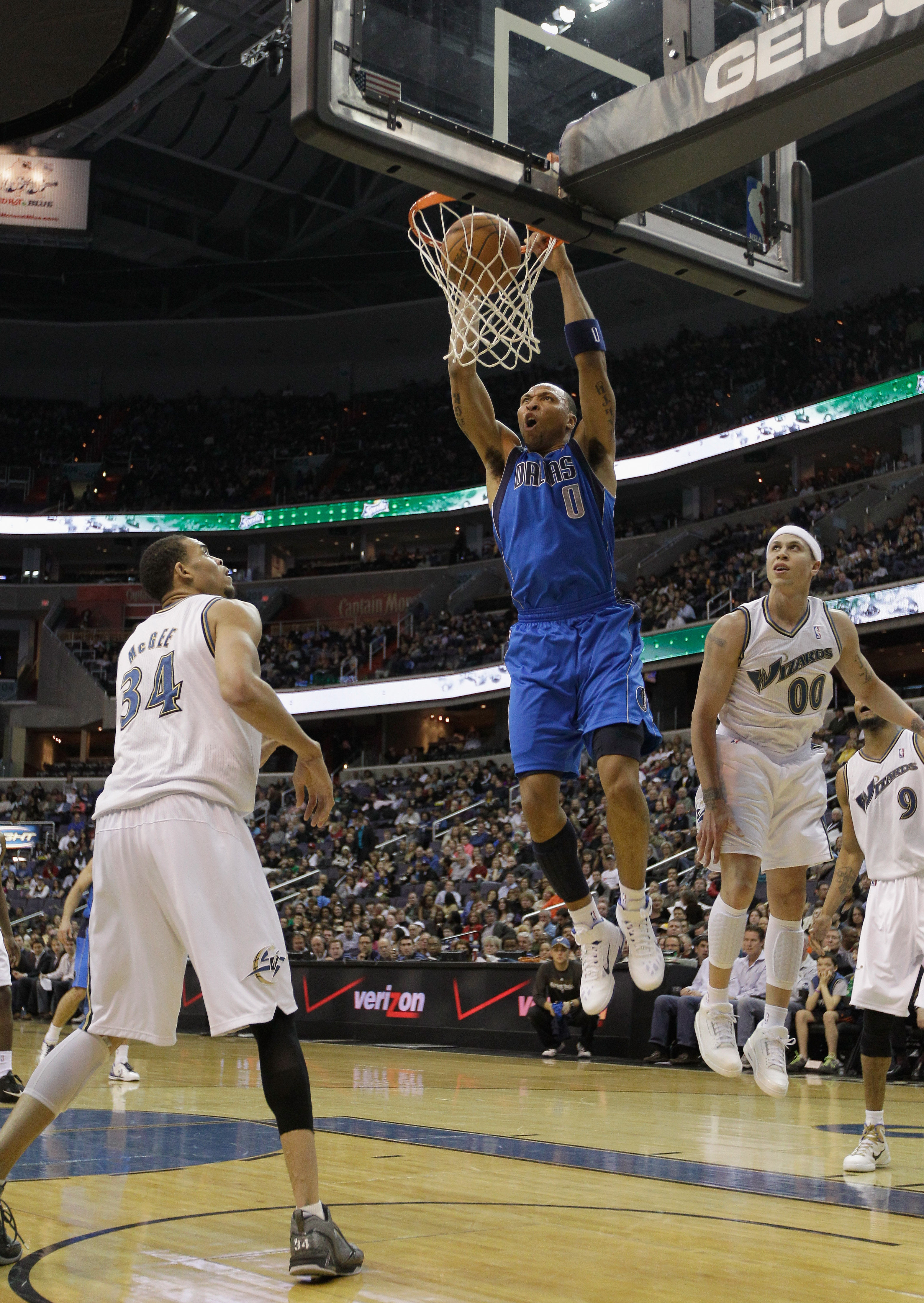 WASHINGTON, DC - FEBRUARY 26: Shawn Marion #0 of the Dallas Mavericks shoots over the defense of Mike Bibby #00 and JaVale McGee #34 of the Washington Wizards at the Verizon Center on February 26, 2011 in Washington, DC. NOTE TO USER: User expressly ackno