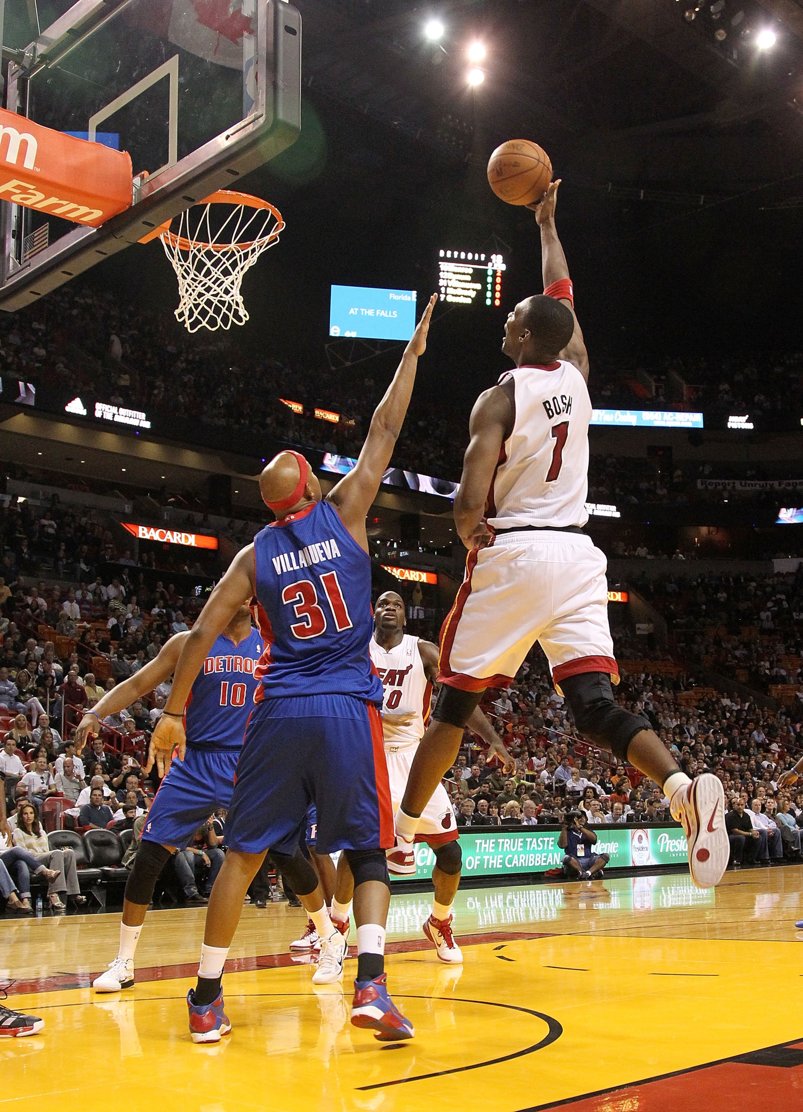 MIAMI, FL - DECEMBER 01: Chris Bosh #1 of the Miami Heat shoots over Charlie Villanueva #31 of the Detroit Pistons during a game at American Airlines Arena on December 1, 2010 in Miami, Florida. NOTE TO USER: User expressly acknowledges and agrees that, b