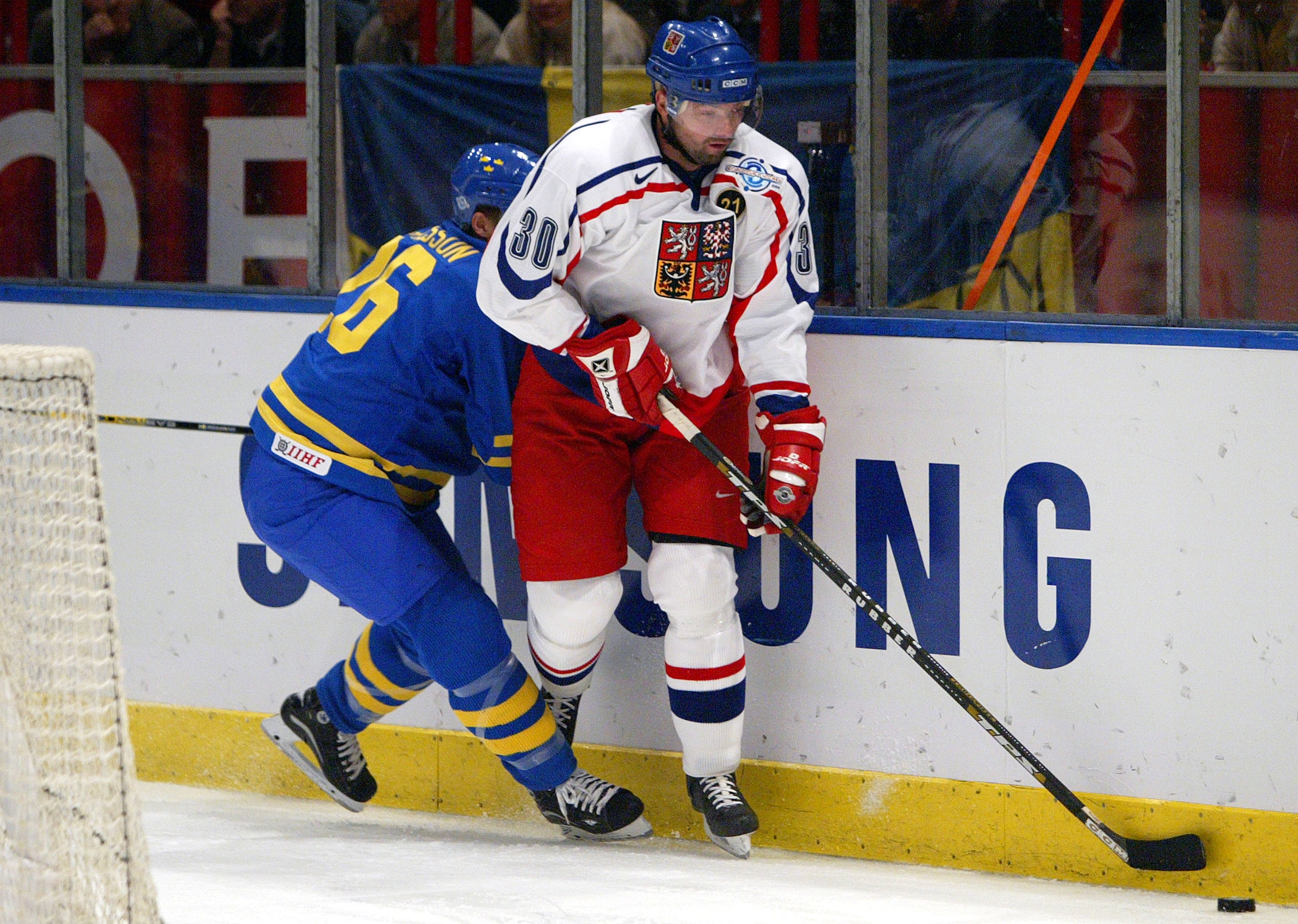 STOCKHOLM, SWEDEN - SEPTEMBER 7: Jiri Dopita #30 of the Czech Republic moves the puck along the boards against Samuel Pahlsson #26 of Sweden during a quarterfinal game in the World Cup of Hockey tournament at the Globe Arena on September 7, 2004 in Stock STOCKHOLM, SWEDEN - SEPTEMBER 7: Jiri Dopita #30 of the Czech Republic moves the puck along the boards against Samuel Pahlsson #26 of Sweden during a quarterfinal game in the World Cup of Hockey tournament at the Globe Arena on September 7, 2004 in Stock