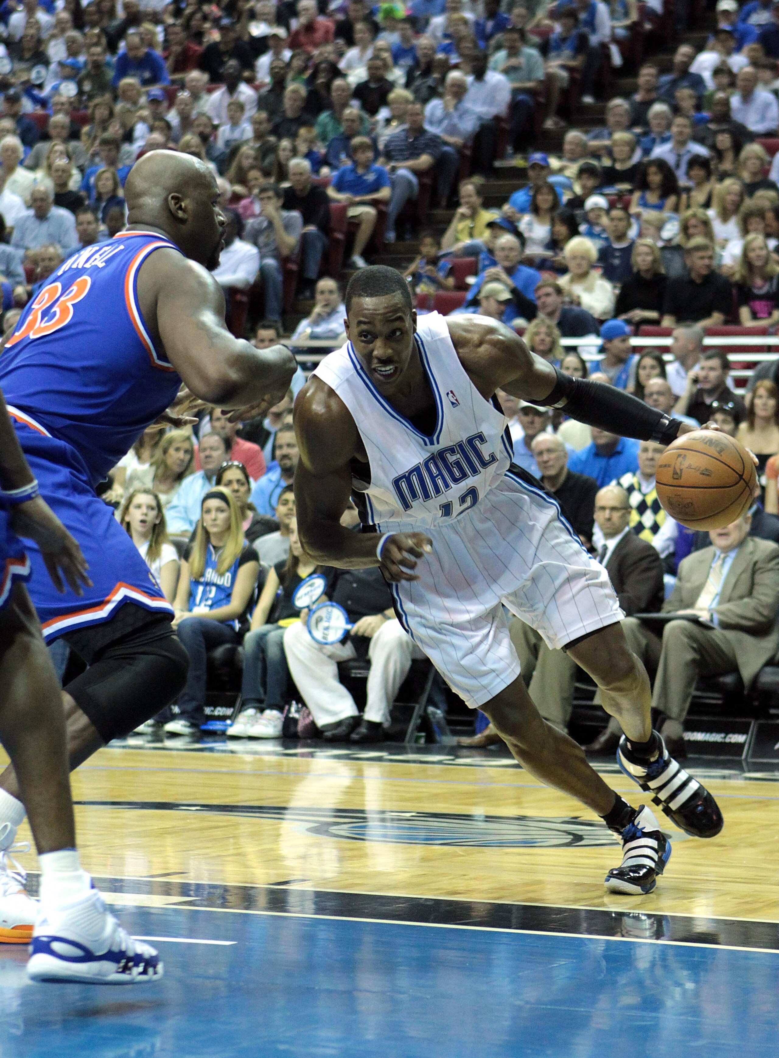 ORLANDO, FL - FEBRUARY 21:  Dwight Howard #12 of the Orlando Magic drives against Shaquille O'Neal #33 of the Cleveland Cavaliers at Amway Arena on February 21, 2010 in Orlando, Florida. NOTE TO USER: User expressly acknowledges and agrees that, by downlo