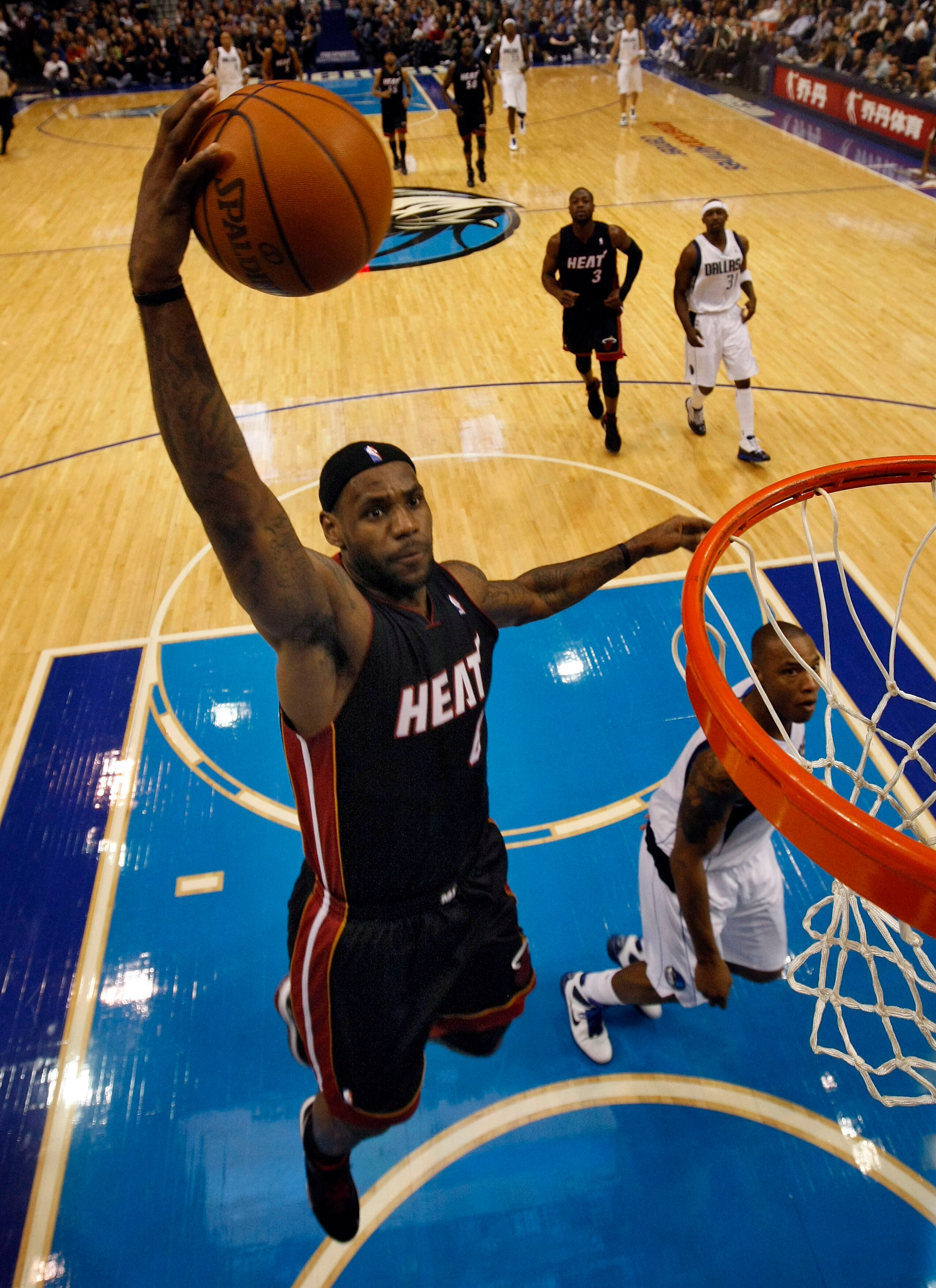 DALLAS - NOVEMBER 27: LeBron James #6 of the Miami Heat dunks on Caron Butler #4 of the Dallas Mavericks on November 27, 2010 at the American Airlines Center in Dallas, Texas. NOTE TO USER: User expressly acknowledges and agrees that, by downloading and o