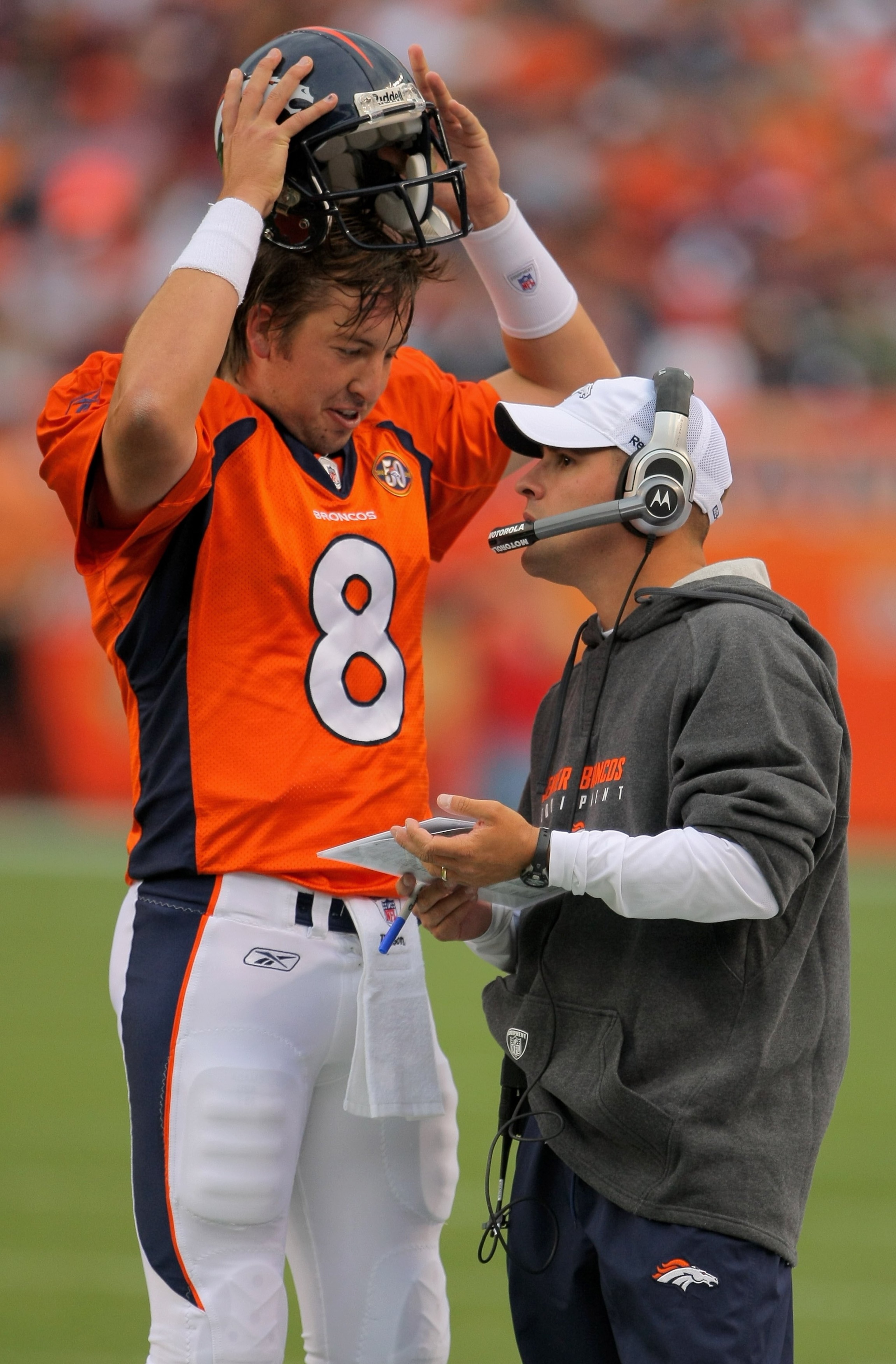 DENVER - AUGUST 30:  Head coach Josh McDaniels of the Denver Broncos talks with quarterback Kyle Orton #8 on the sidelines as they face the Chicago Bears during preseason NFL action at INVESCO Field at Mile High on August 30, 2009 in Denver, Colorado. The