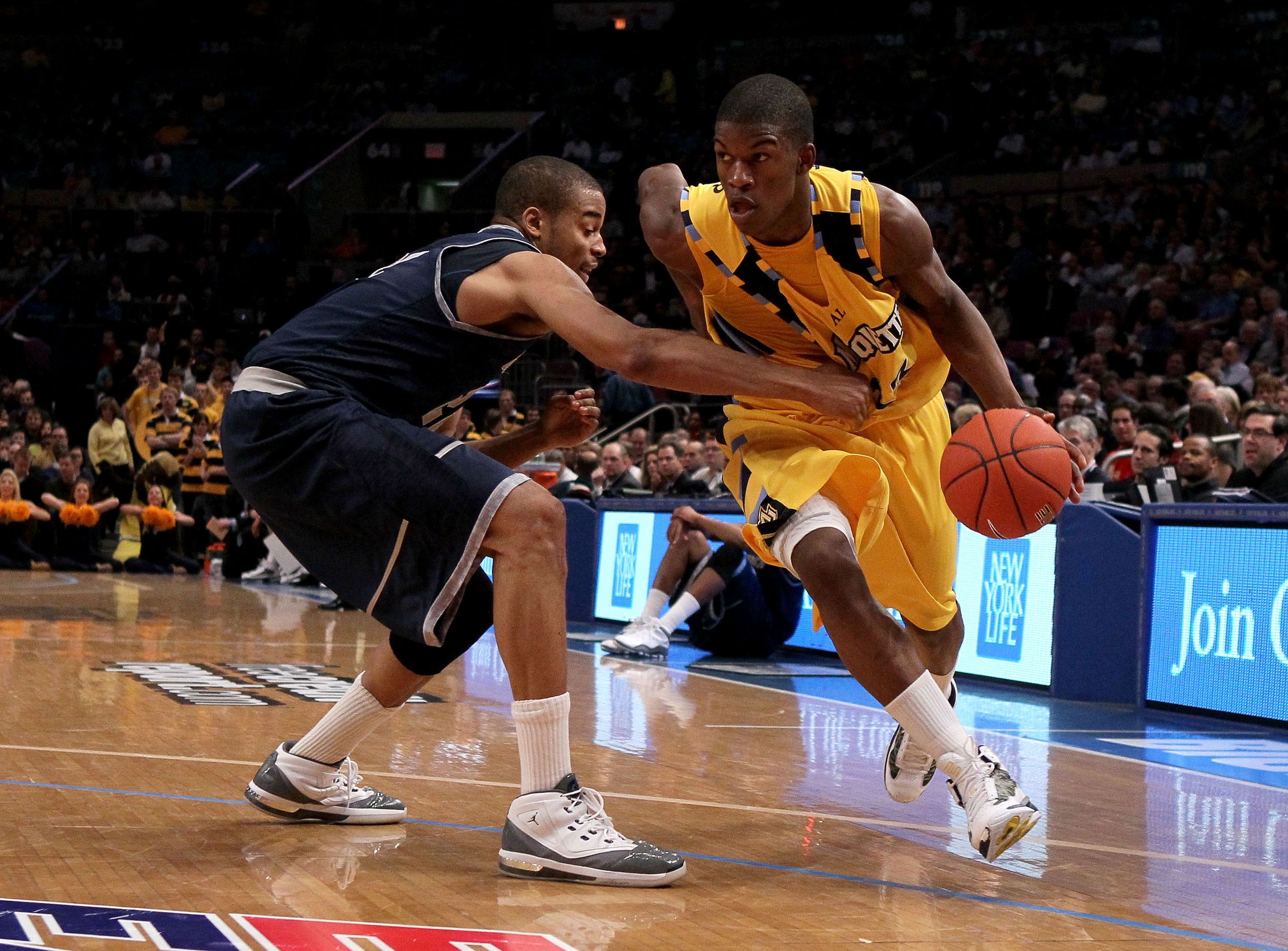 NEW YORK - MARCH 12: Jimmy Butler #33 of the Marquette Golden Eagles handles the ball against Julian Vaughn #22 of the Georgetown Hoyas during the semifinal of the 2010 Big East Tournament at Madison Square Garden on March 12, 2010 in New York City.  (Pho