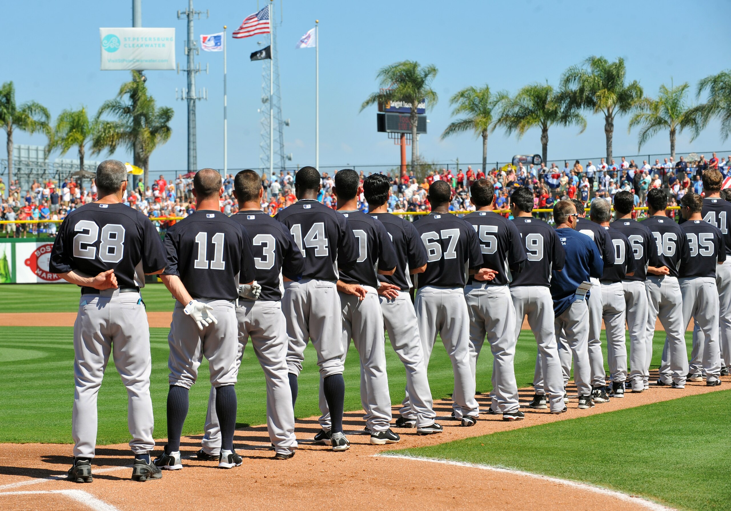 CLEARWATER, FL - FEBRUARY 27:  Manager Joe Girardi #28 and players of the New York Yankees line up for pre-game introduction before play  against the Philadelphia Phillies February 27, 2011 at Bright House Field in Clearwater, Florida.  (Photo by Al Messe