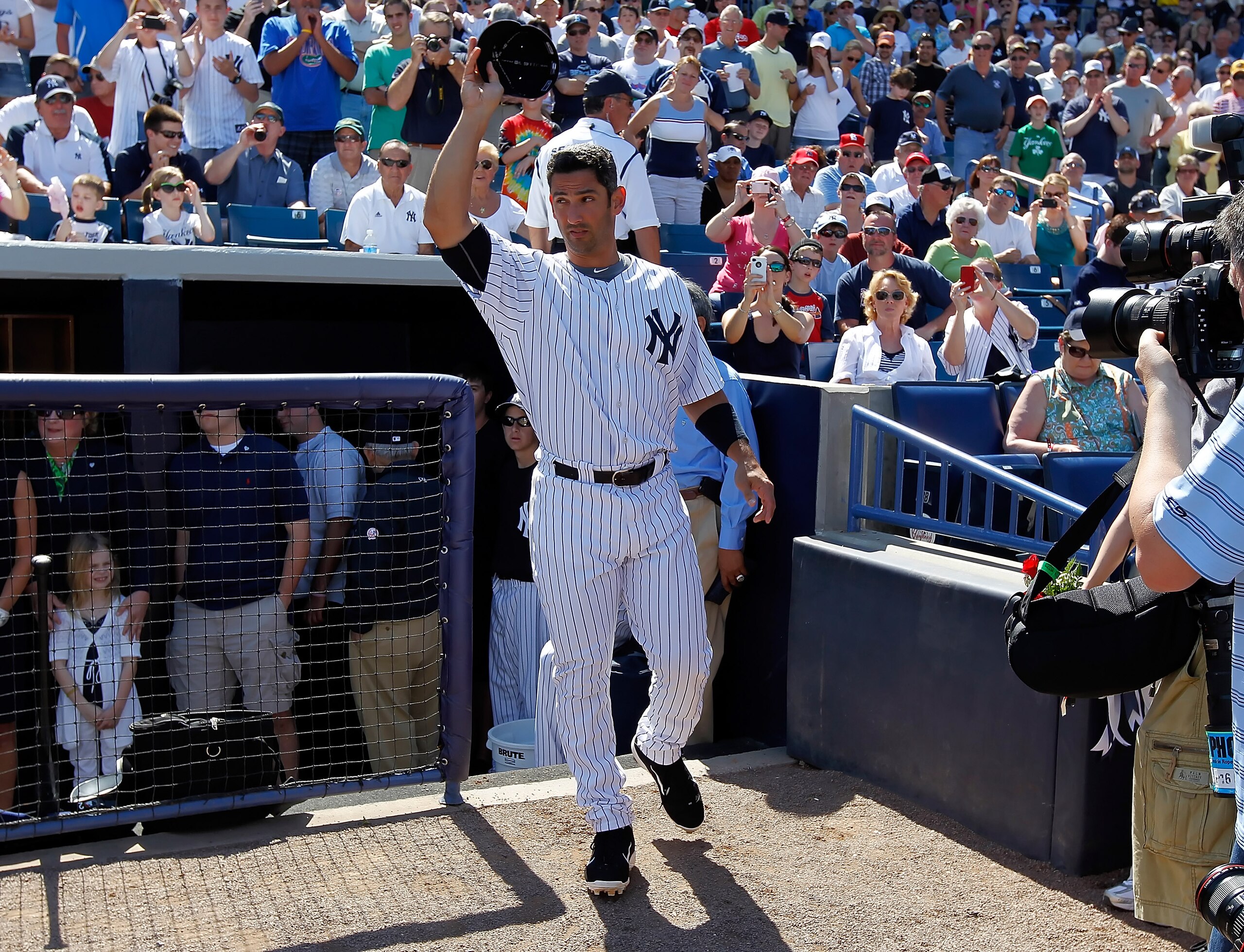 TAMPA, FL - FEBRUARY 26:  Designated hitter Jorge Posada #20 of the New York Yankees tips his hat to the crowd as he is announced just prior to the start of the Grapefruit League Spring Training Game against the Philadelphia Phillies at George M. Steinbre