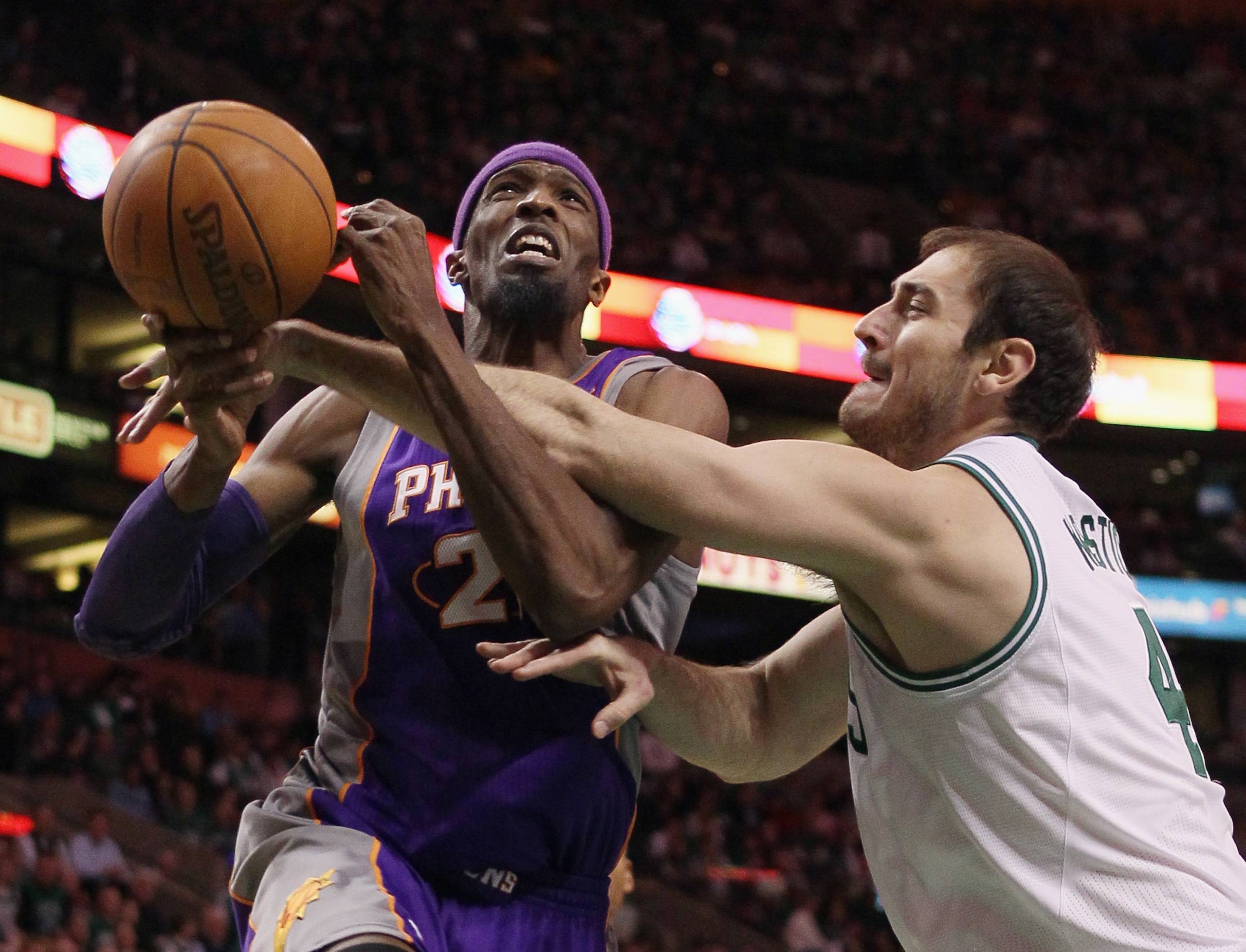 BOSTON, MA - MARCH 02:  Hakim Warrick #21 of the Phoenix Suns is fouled by Nenad Krstic #4 of the Boston Celtics on March 2, 2011 at the TD Garden in Boston, Massachusetts.  The Celtics defeated the Suns 115-103. NOTE TO USER: User expressly acknowledges