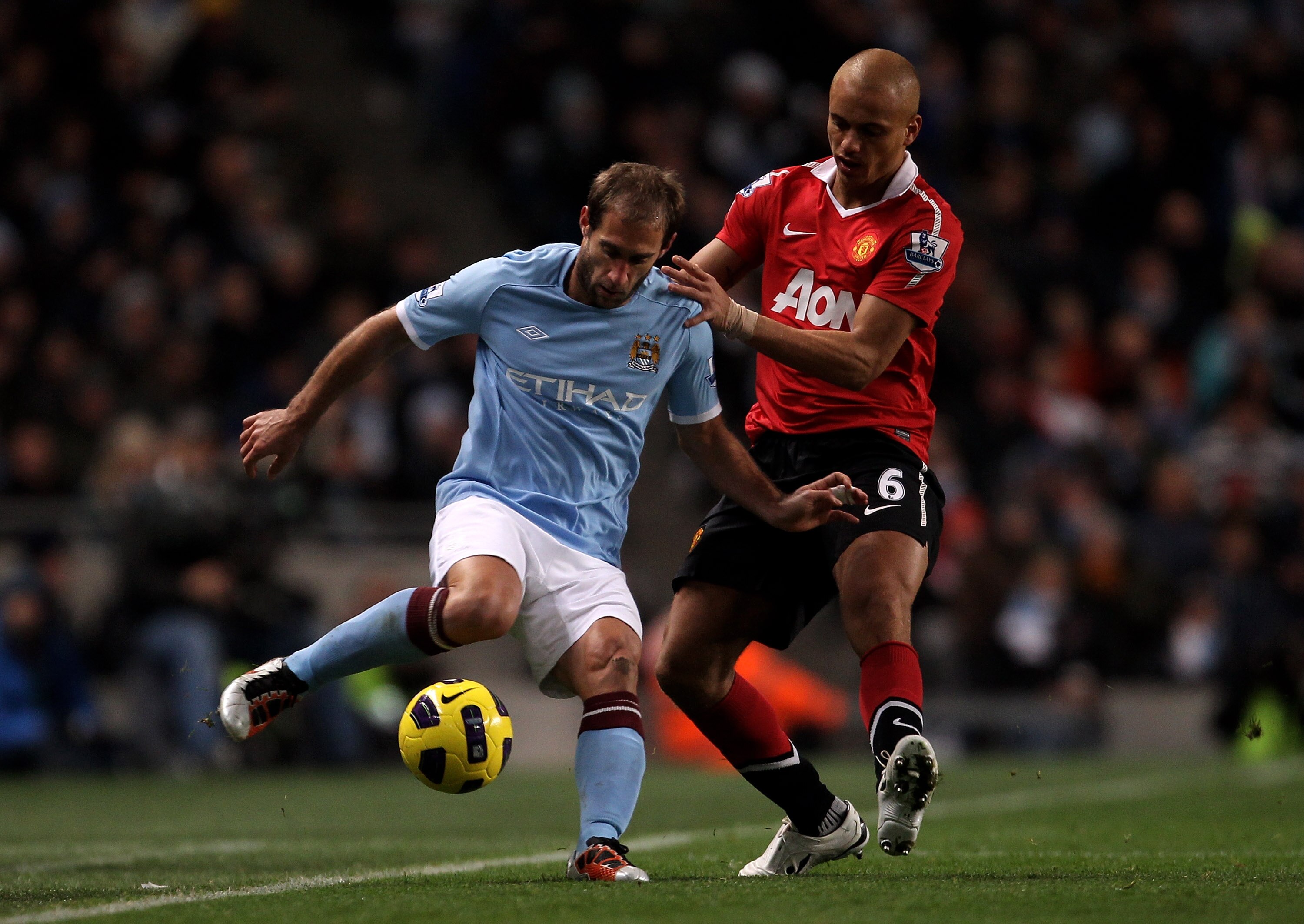 MANCHESTER, UNITED KINGDOM - NOVEMBER 10:   Pablo Zabaleta of Manchester City is challenged by Wes Brown of Manchester United during the Barclays Premier League match between Manchester City and Manchester United at the City of Manchester Stadium on Novem