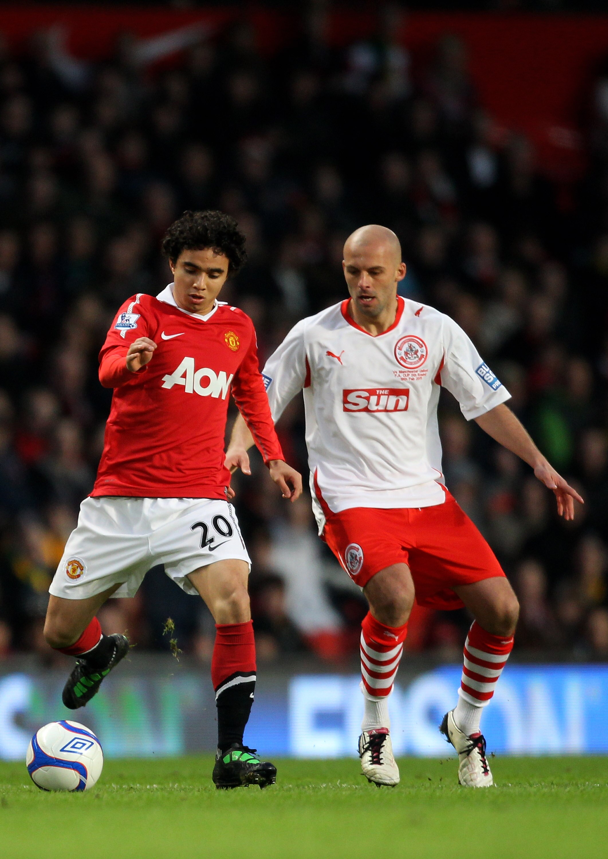 MANCHESTER, ENGLAND - FEBRUARY 19:  Fabio Da Silva of Manchester United is challenged by David Hunt of Crawley Town during the FA Cup sponsored by E.ON 5th round match between Manchester United and Crawley Town at Old Trafford on February 19, 2011 in Manc