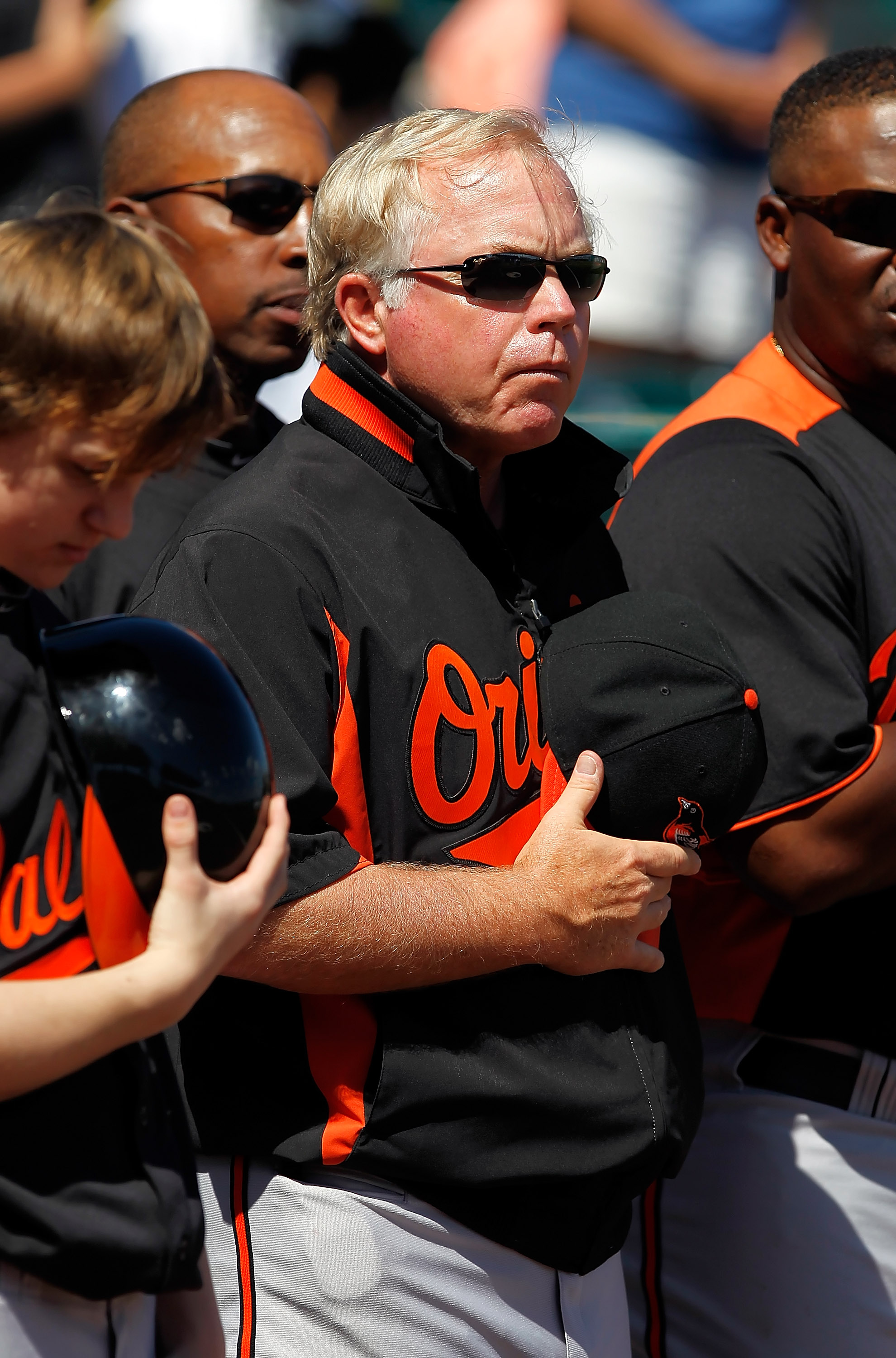 BRADENTON, FL - FEBRUARY 28:  Manager Buck Showalter #26 of the Baltimore Orioles stands for the National Anthem just before the start of the Grapefruit League Spring Training Game against the Pittsburgh Pirates at McKechnie Field on February 28, 2011 in