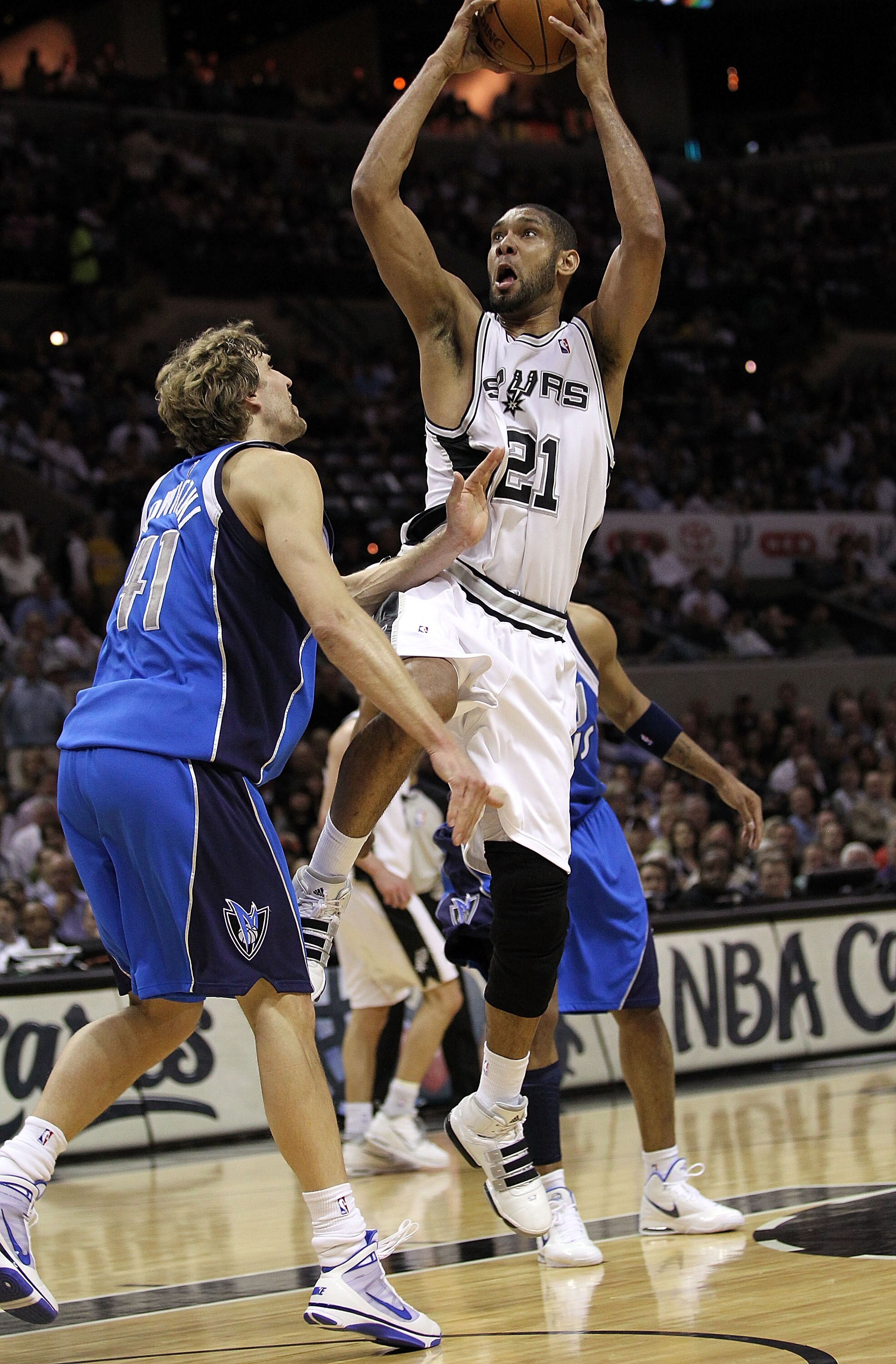 SAN ANTONIO - APRIL 23:  Forward Tim Duncan #21 of the San Antonio Spurs takes a shot against Dirk Nowitzki #41 of the Dallas Mavericks in Game Three of the Western Conference Quarterfinals during the 2010 NBA Playoffs at AT&T Center on April 23, 2010 in