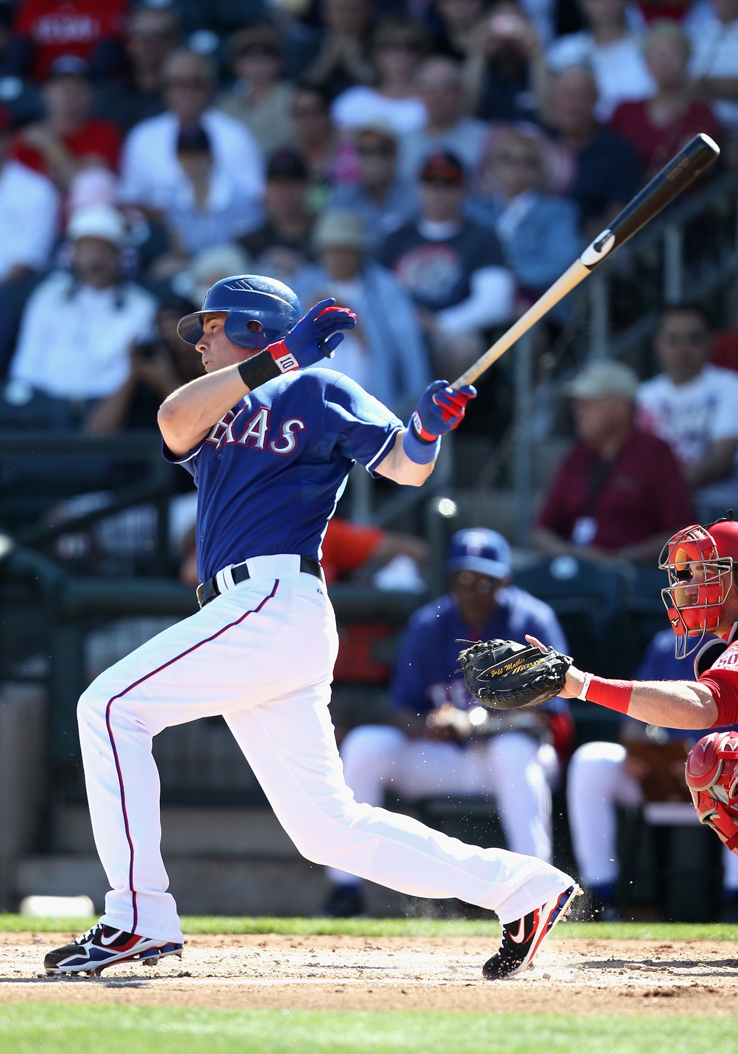 SURPRISE, AZ - MARCH 02:  Michael Young #10 of the Texas Rangers hits a single against the Los Angeles Angels of Anaheim during the second inning of the spring training game at Surprise Stadium on March 2, 2011 in Surprise, Arizona.  (Photo by Christian P